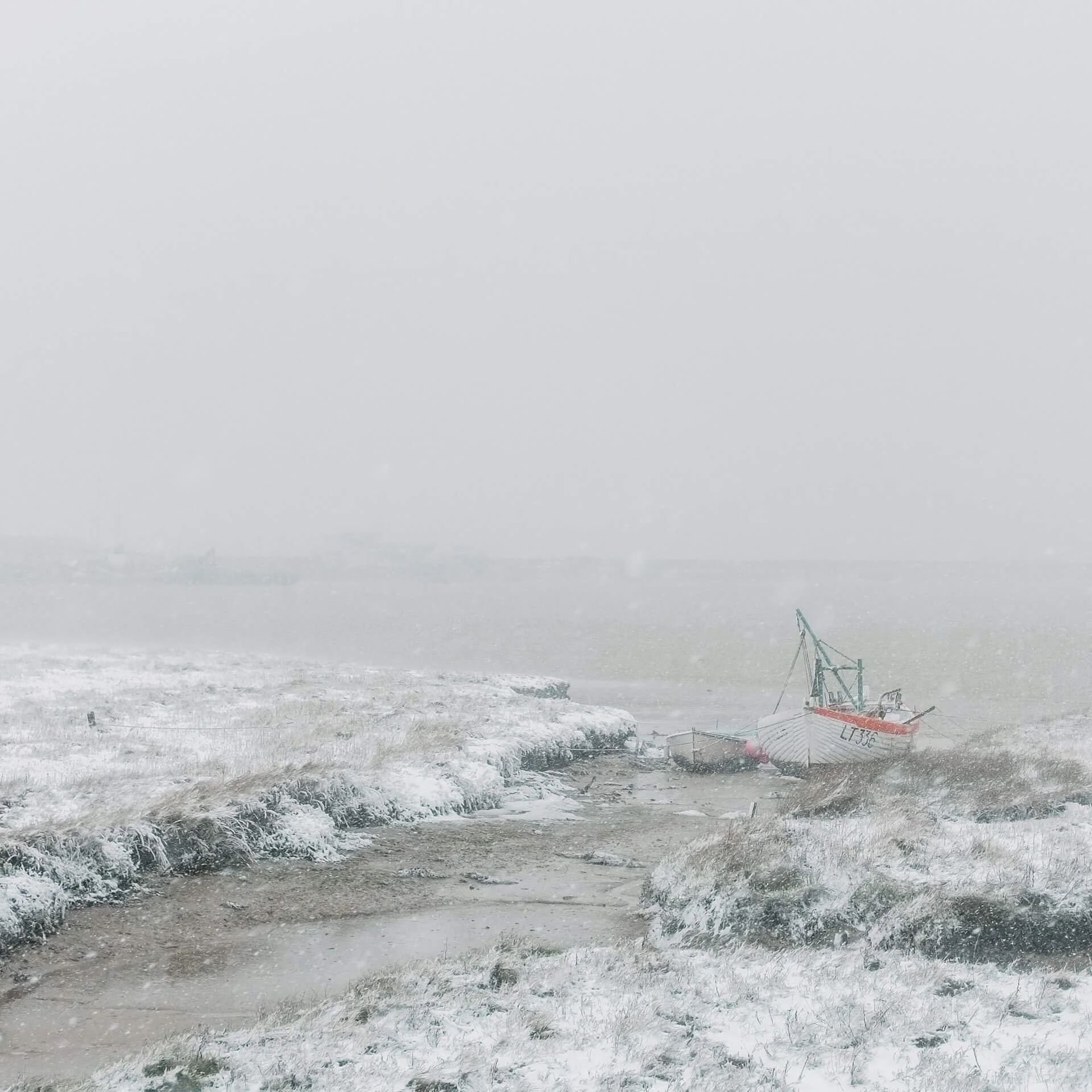 Boats at Slaughden Quay in the snow