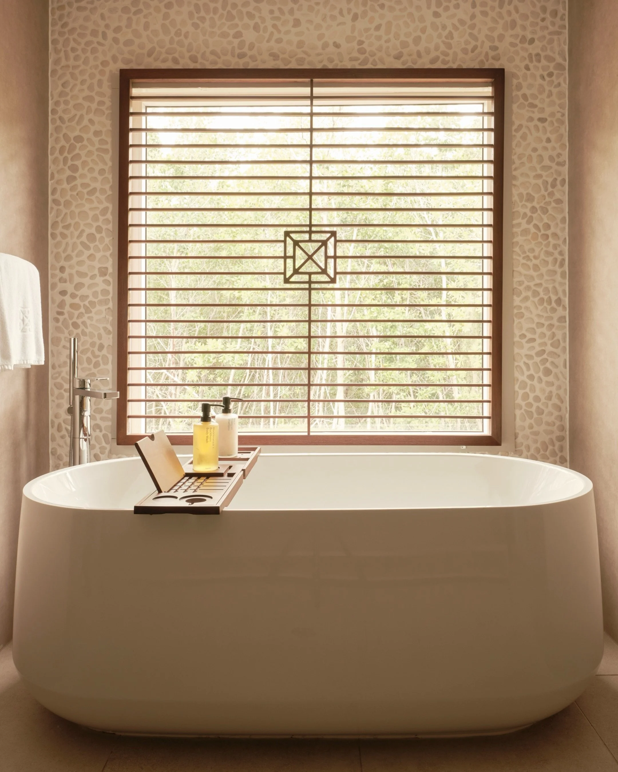Warm water gathers around you, infused with the soft fragrance of lavender. The steam rises, carrying notes of earth and bloom, while the garden beyond whispers stillness. Muscles loosen, breath deepens, and the world slows to a quiet pause.

This is
