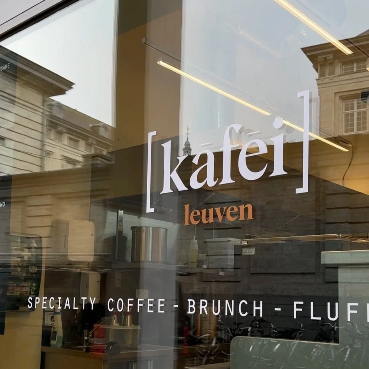 Close-up view of Kafei Leuven sticker on the window