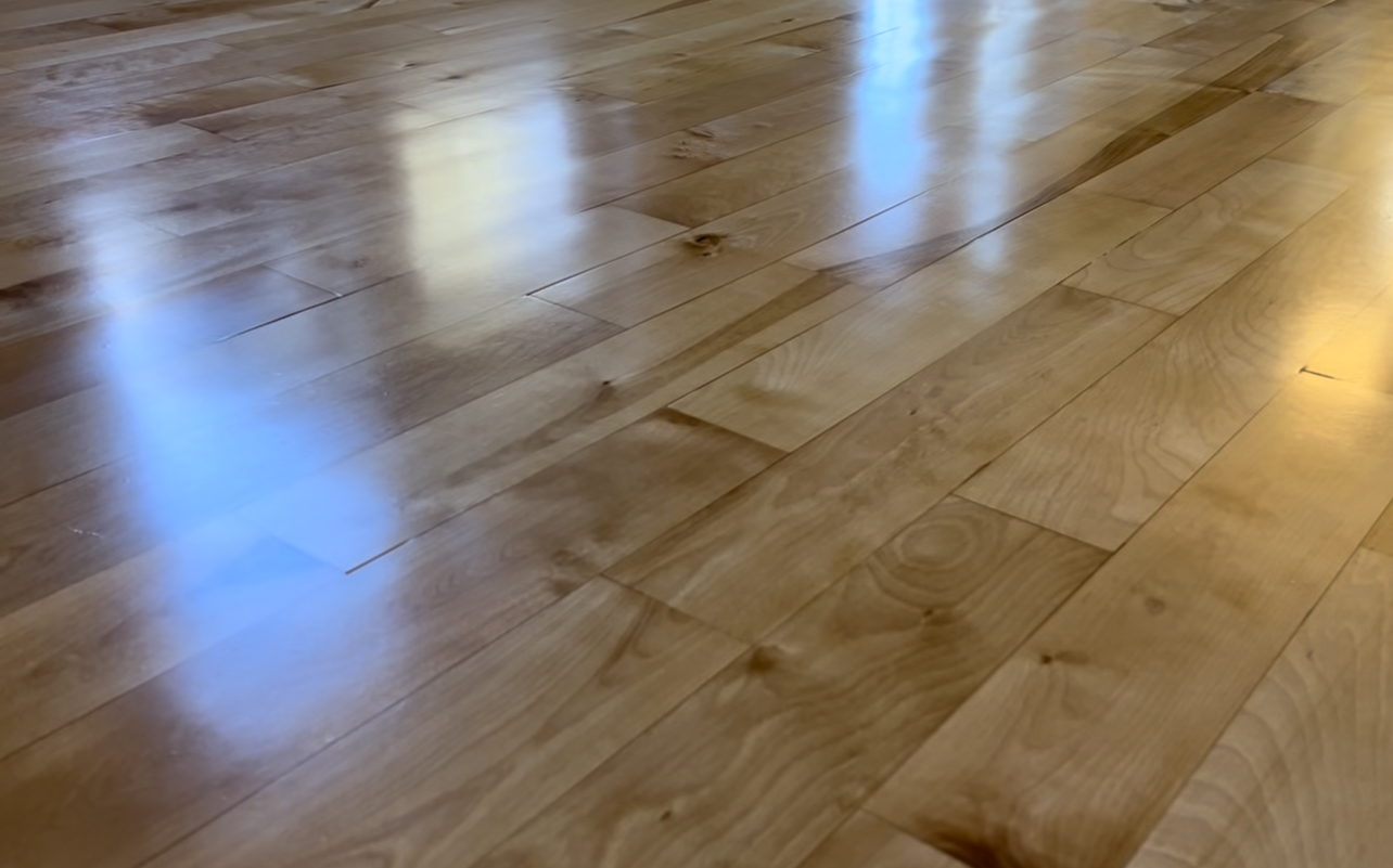 alt="Polished hardwood floor inside renovated Muskoka cottage"