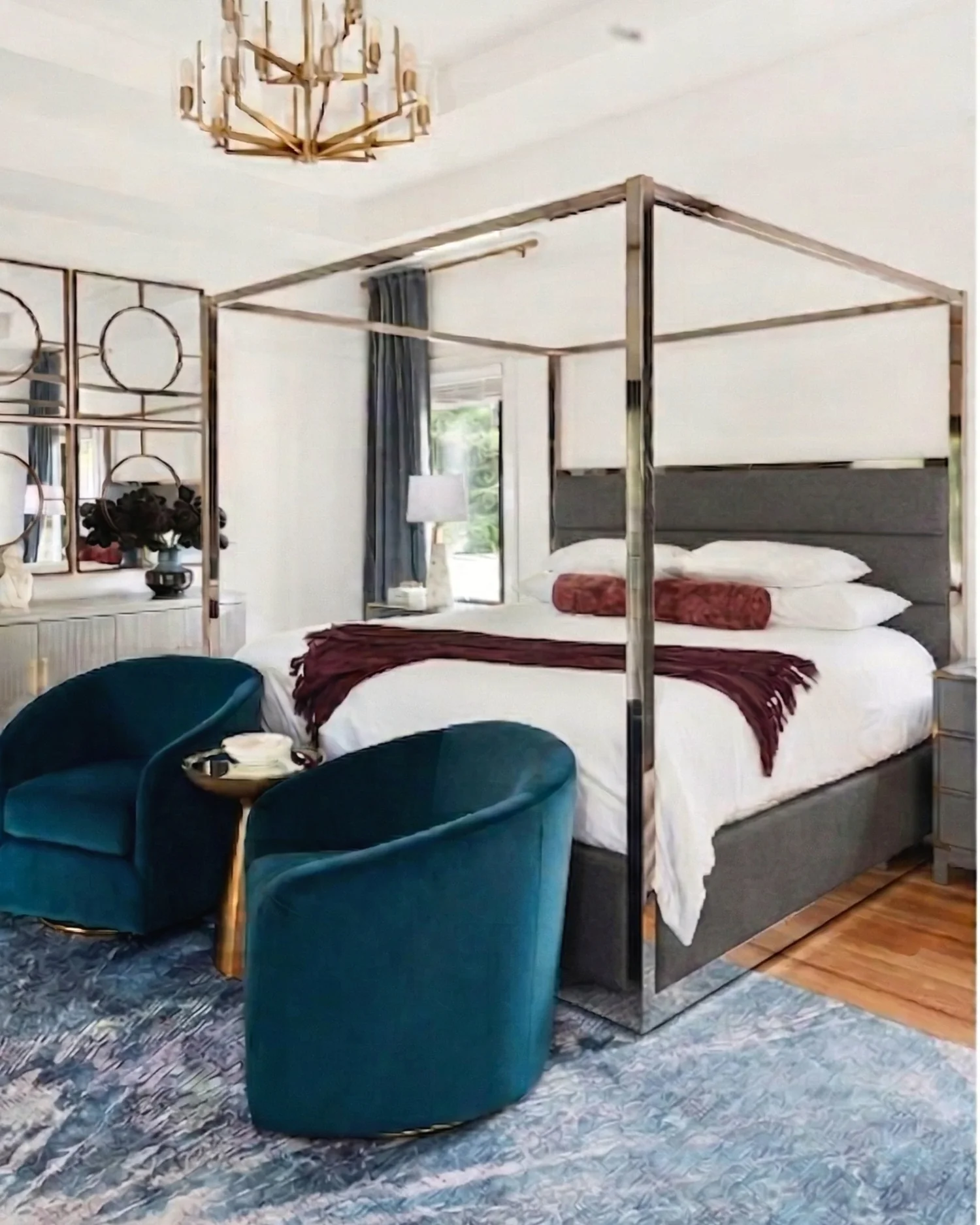 Editorial bedroom with canopy bed and teal chairs