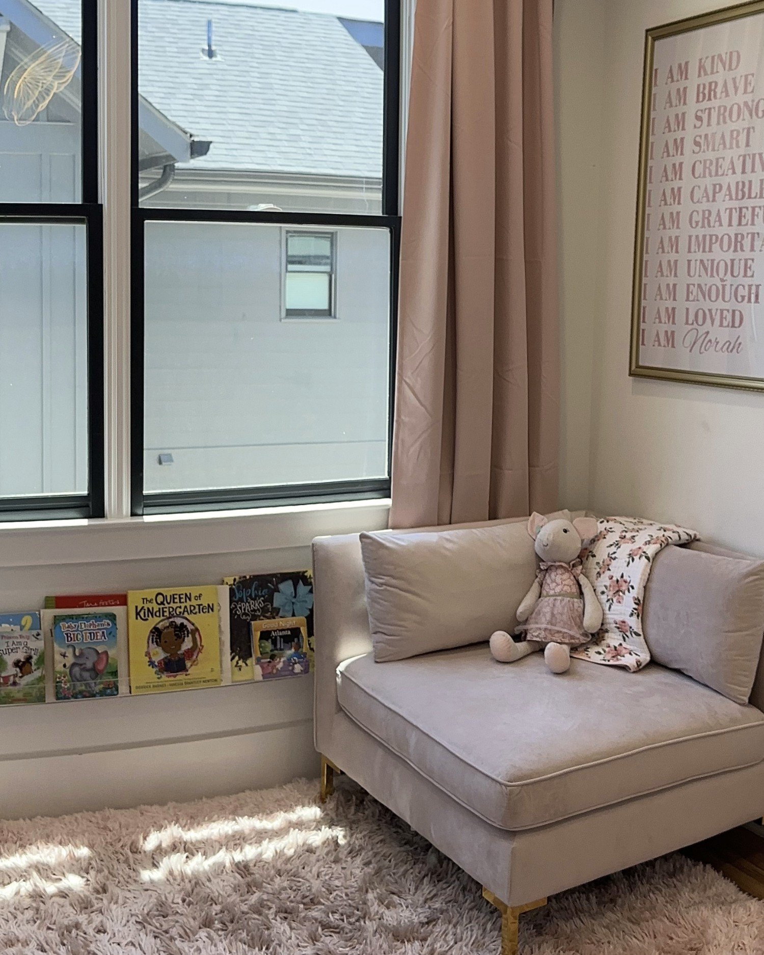 Reading corner with chair and books in the Butterfly Room