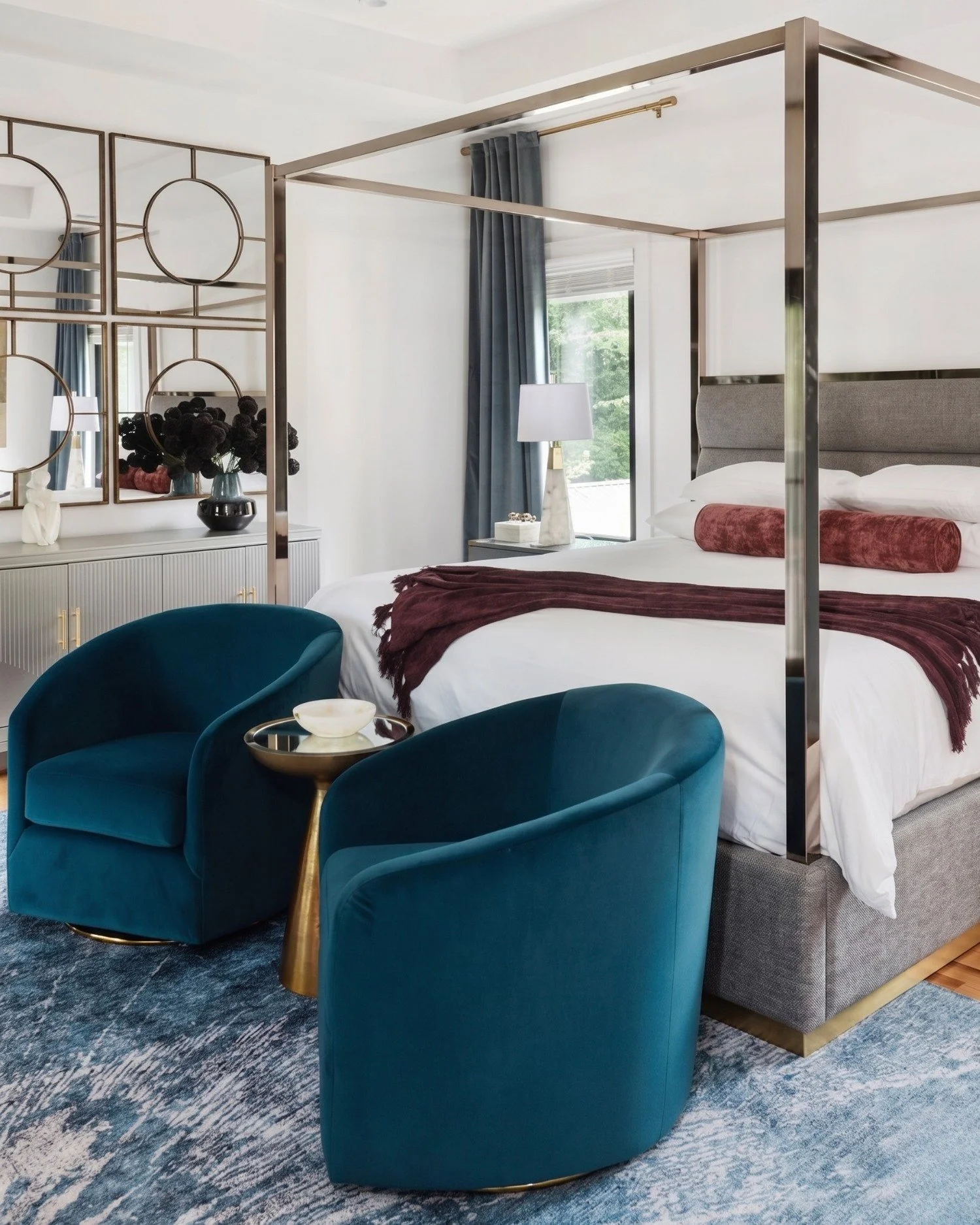Monument Avenue primary bedroom with canopy bed, teal chairs, and layered textures