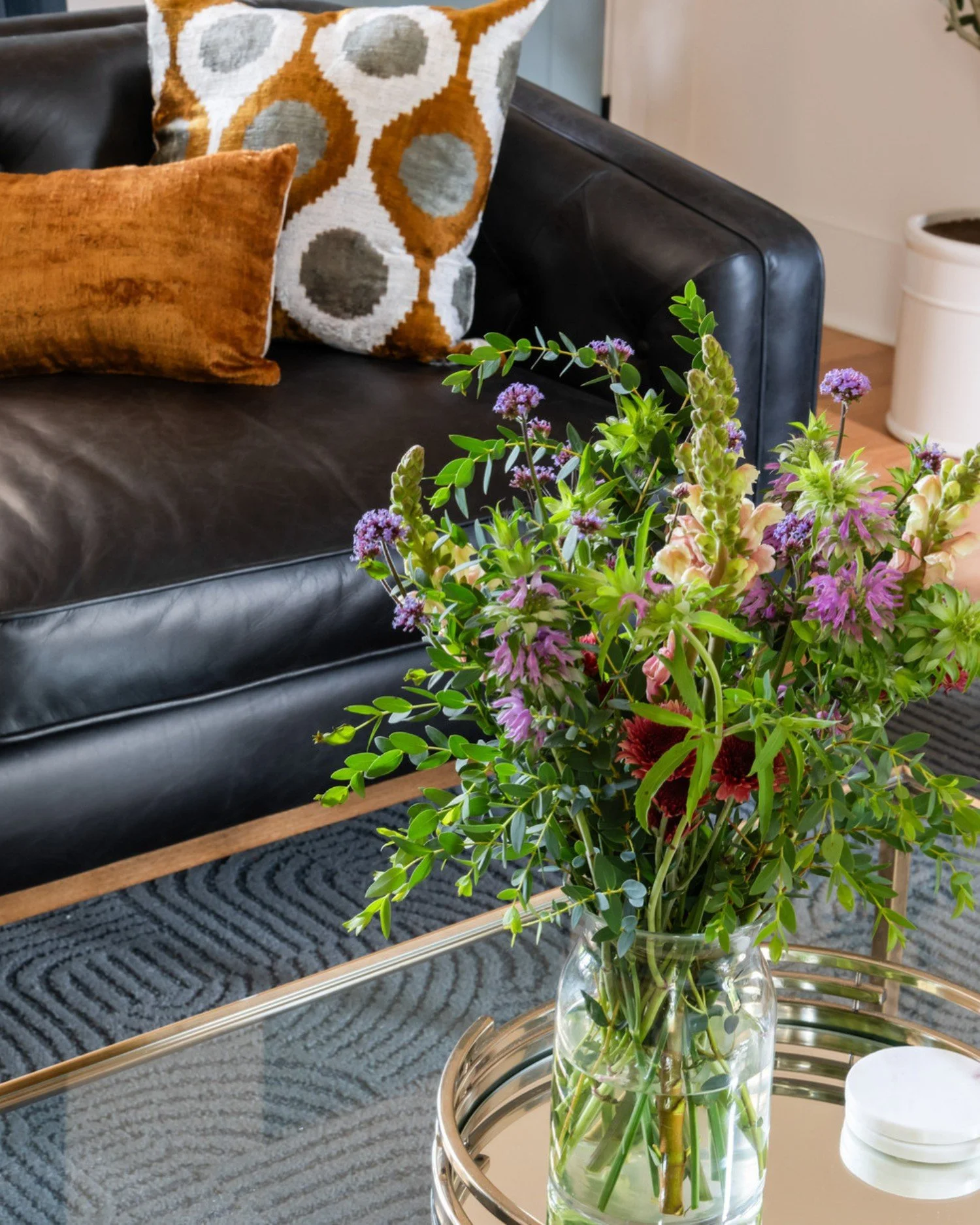 Coffee table styling detail with florals and tray