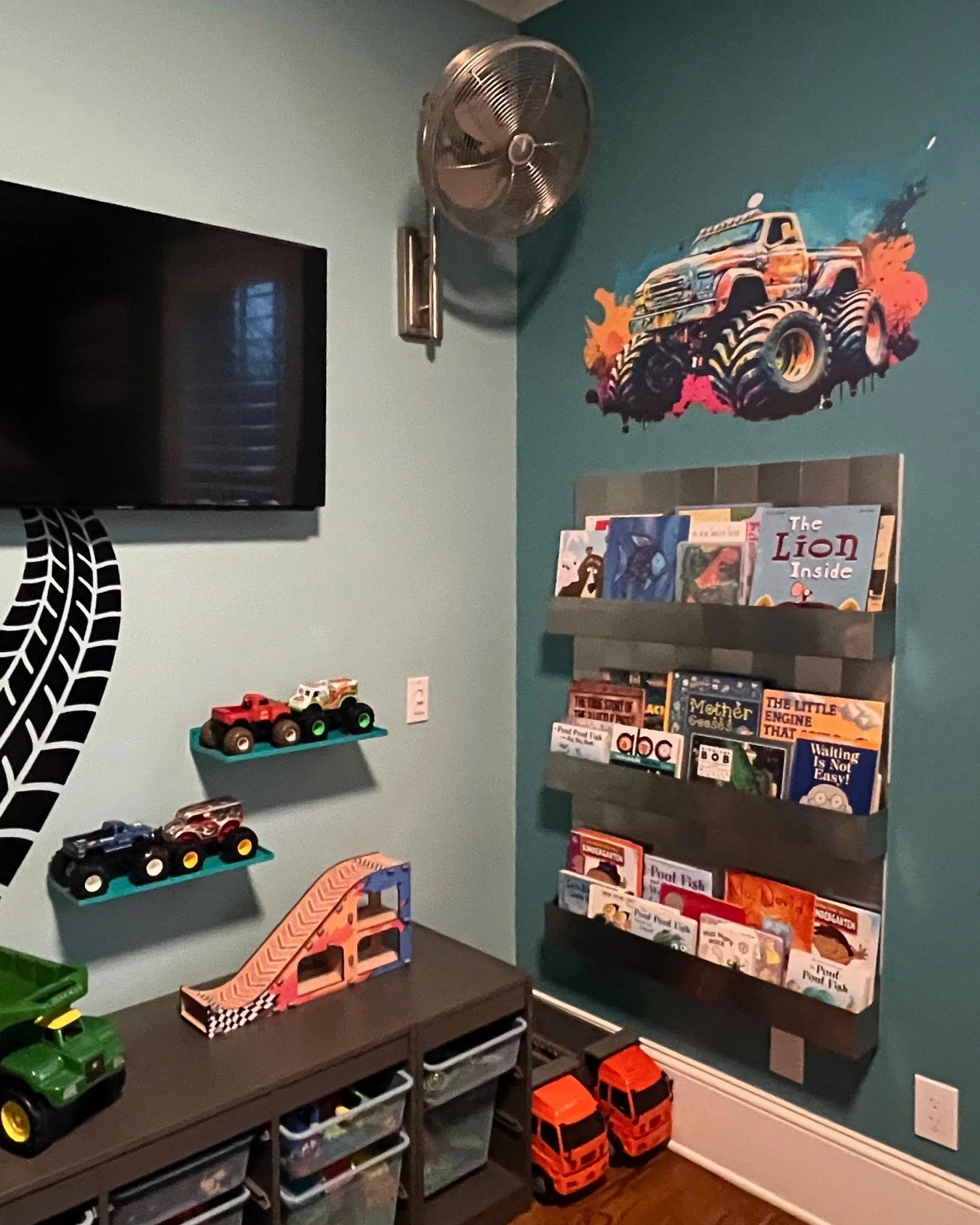 Monster truck children's room with graphic wall and book display