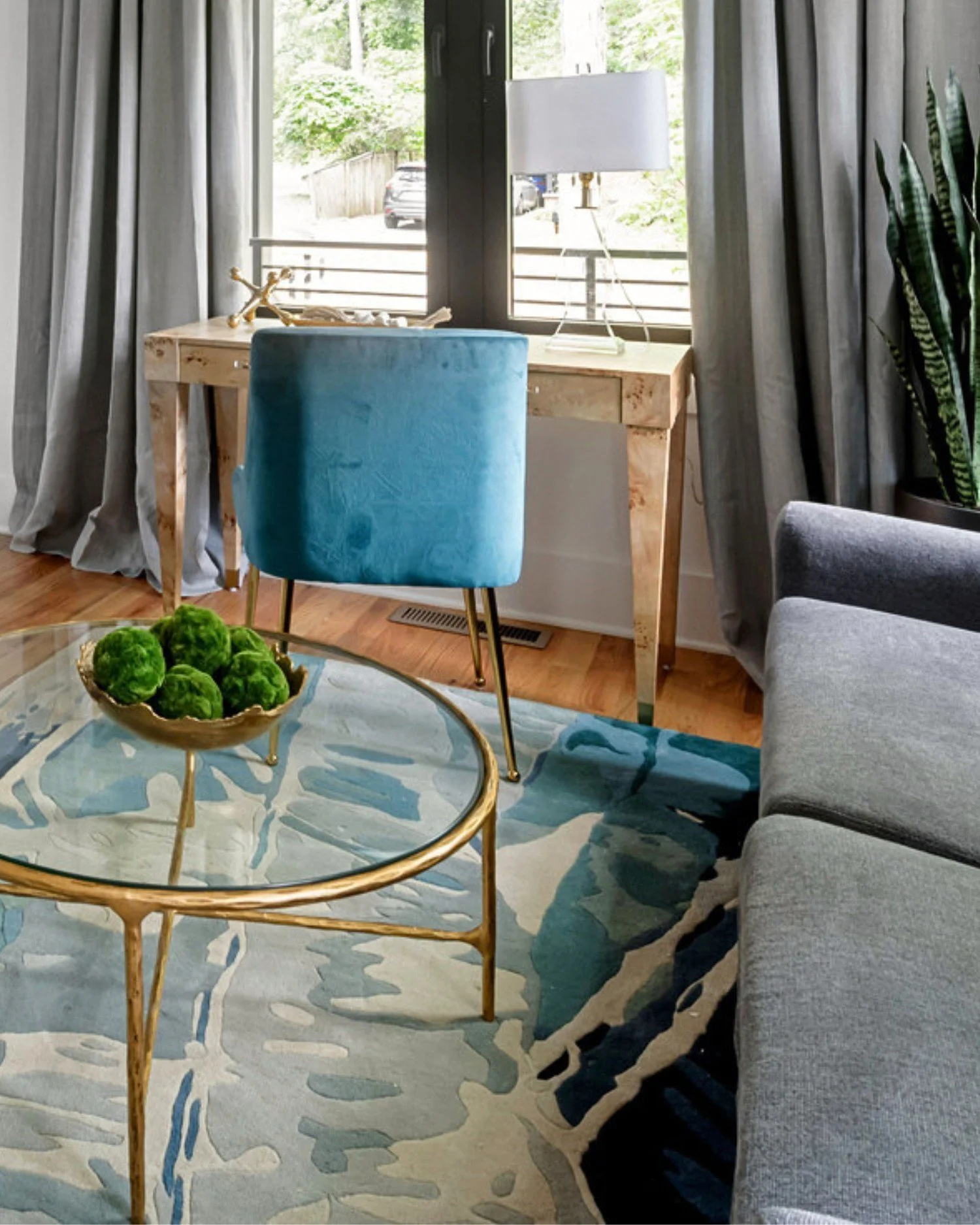 Monument Avenue office vignette with teal chair, light wood desk, and soft natural light