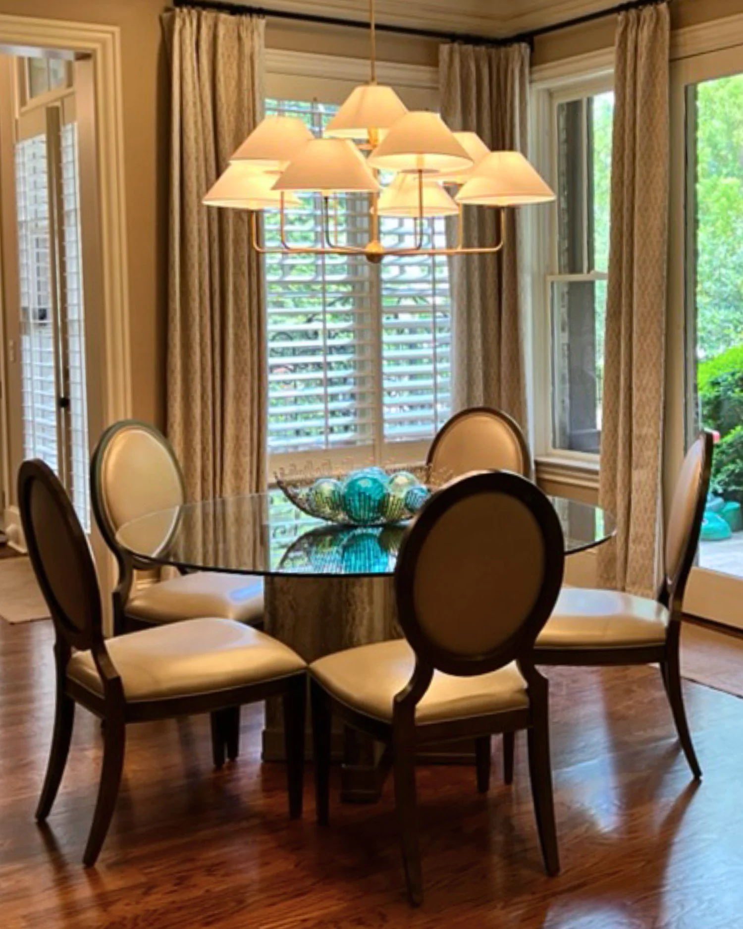 Dining space with chandelier and glass table
