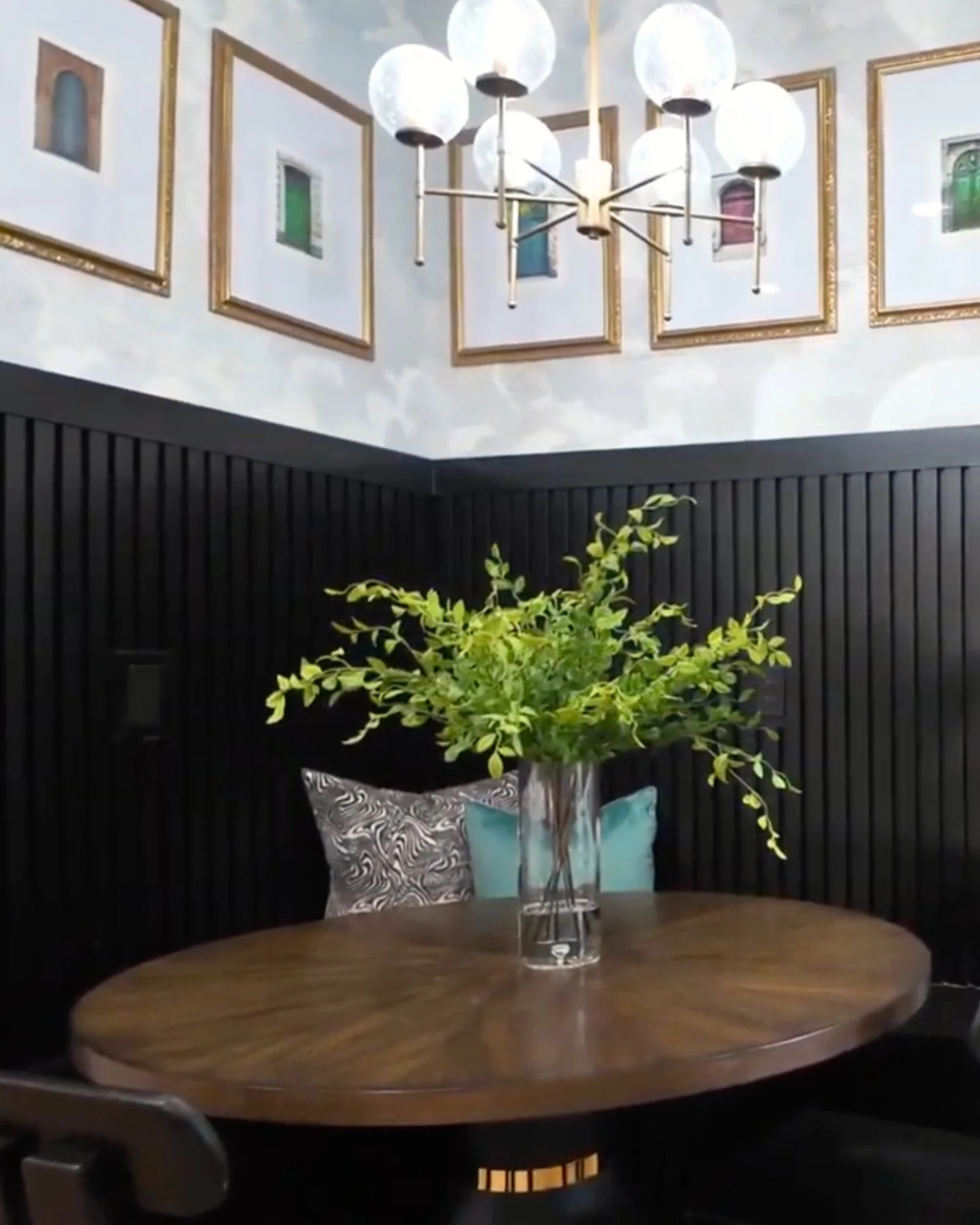 Monument Avenue dining nook with wallpaper, artwork, and plant