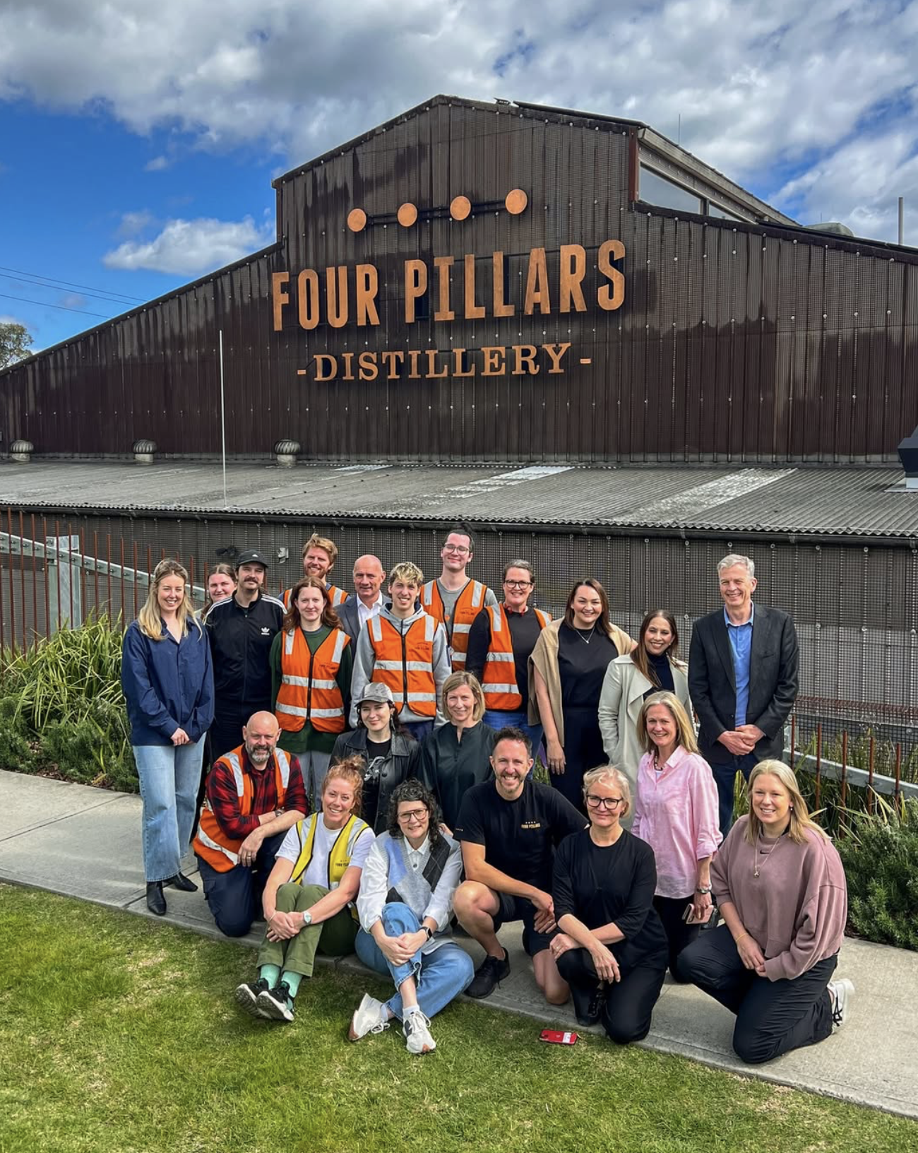Group of Four Pillars Distillery team members standing outdoors in front of the distillery building in Yarra Valley
