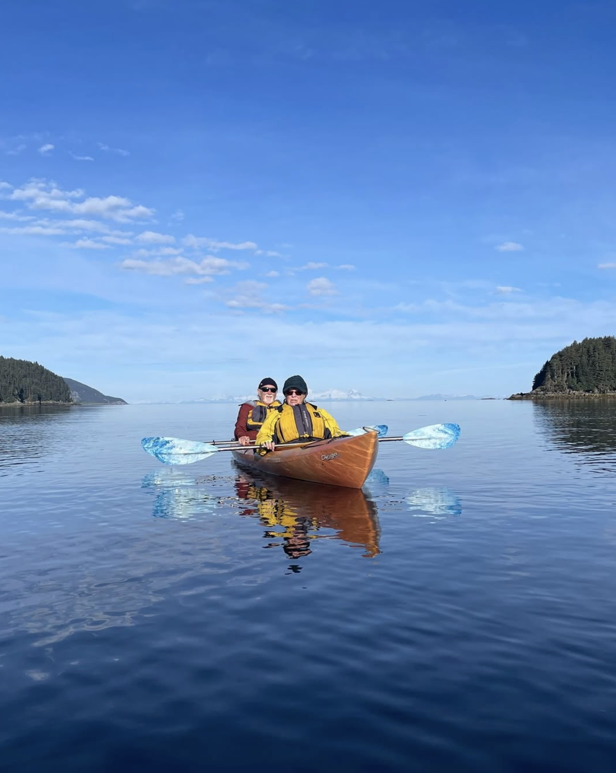 Guests kayaking in calm glacier waters on an UnCruise Adventures expedition in Alaska