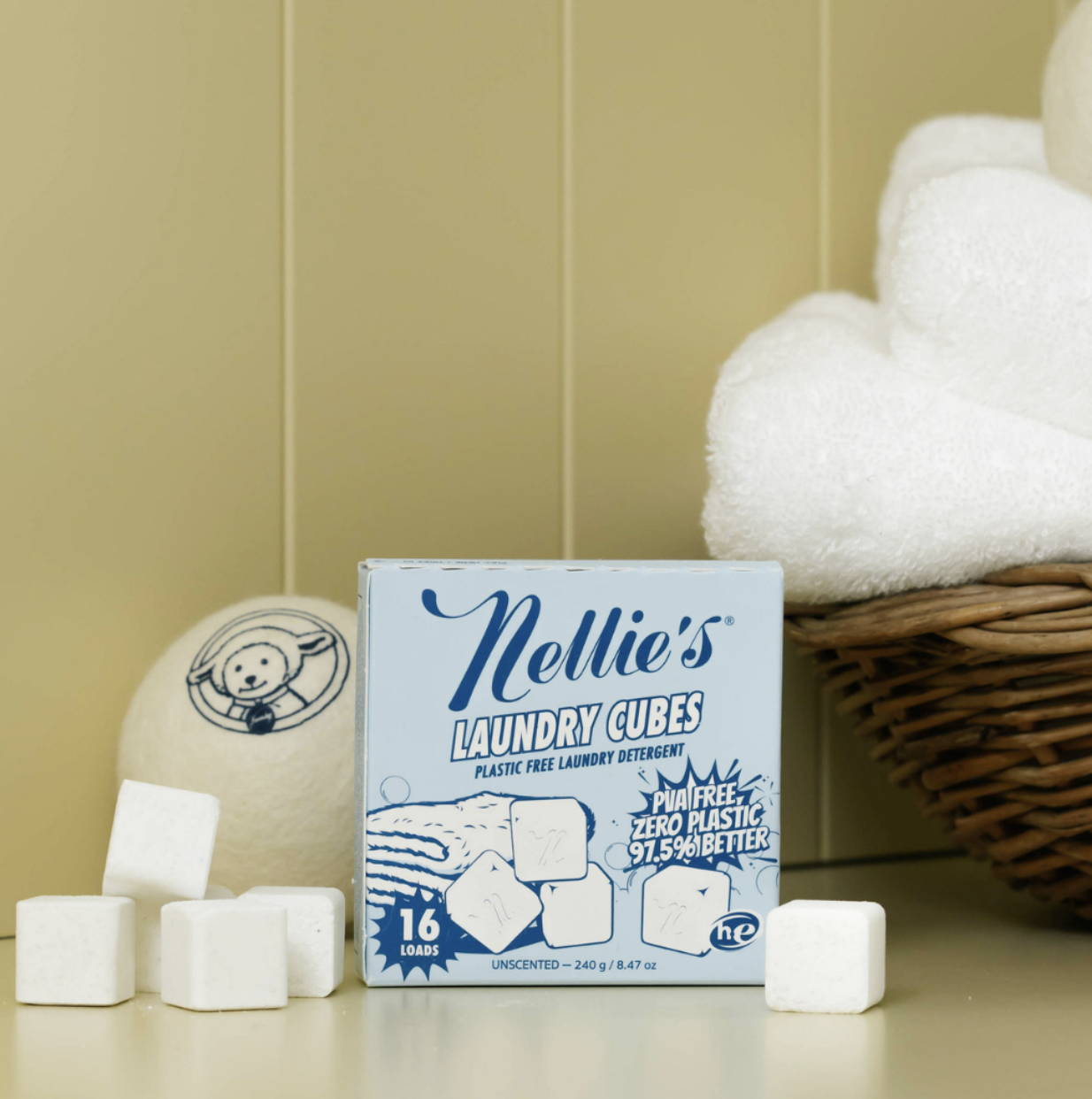 Image 3 Nellie’s Laundry Cubes and reusable wool dryer balls displayed beside folded towels, highlighting plastic-free laundry alternatives.