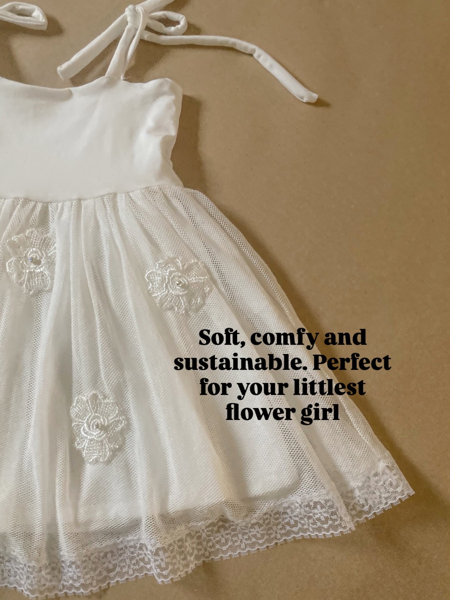 These cute flowered I have hand sewn all over the organic cotton tulle skirt and embellished in the centre with a crystal bead. It wasn&rsquo;t the quickest creation. Trimmed with lace around the gathered skirt this sustainable flower girl dress is s