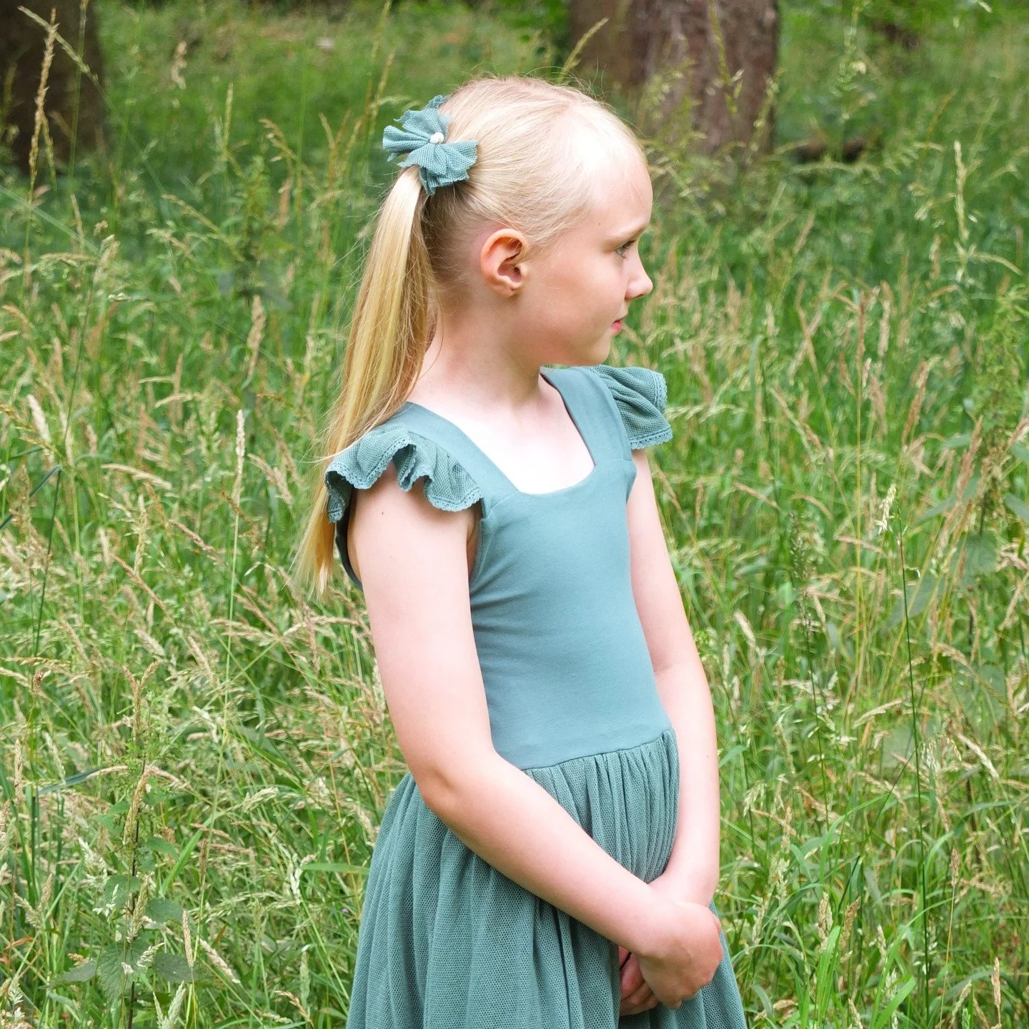 The blossom dress was designed for her to love wearing. Comfy and stretchy for self dressing and ease of movement, plus you can chuck it in the washing machine after she has had lots of fun in it. (Sorry it will need ironing! But a little bit of iron