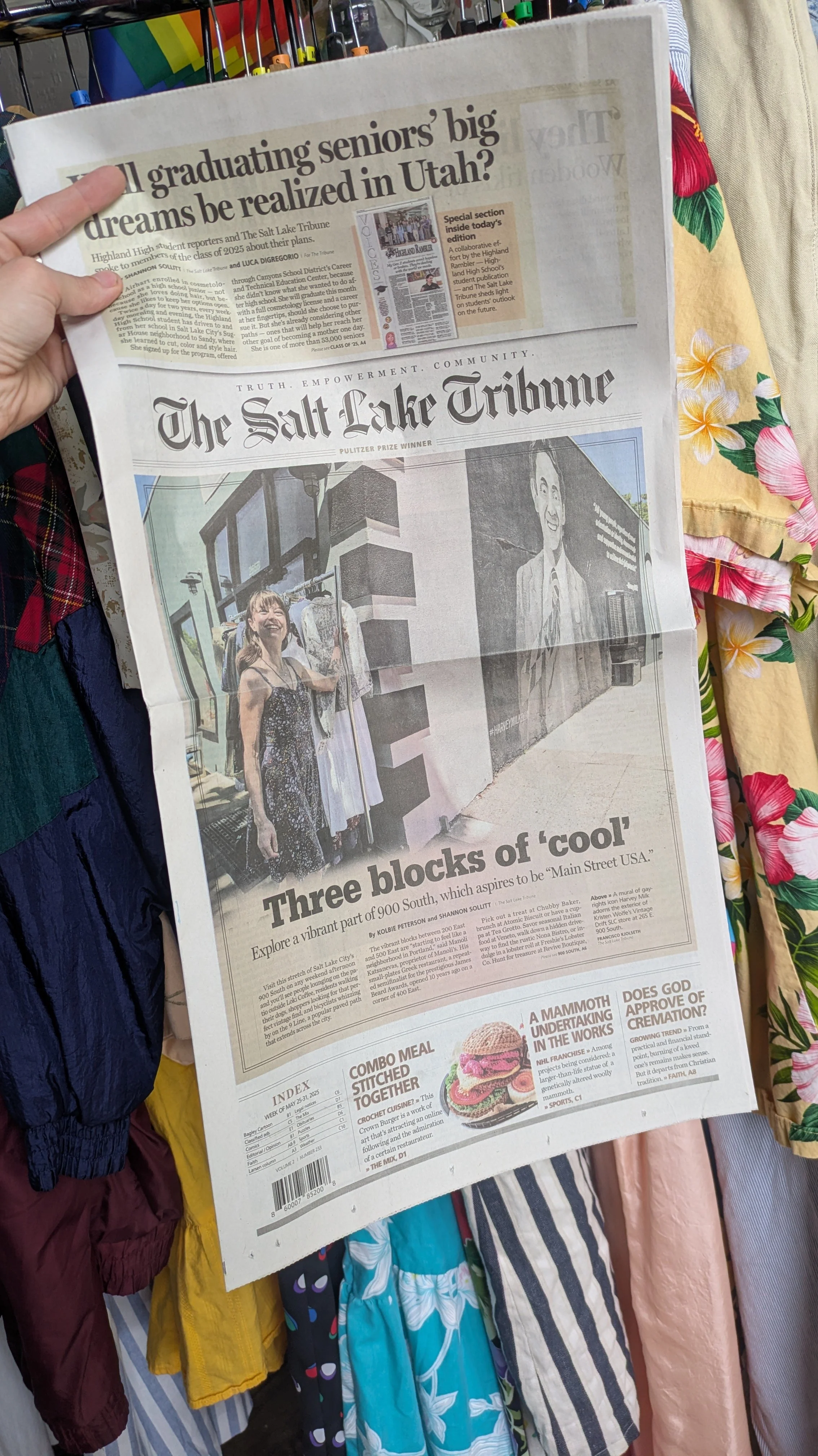 Front page of The Salt Lake Tribune newspaper featuring a large photo of a woman smiling and shopping for clothes outside a storefront with skateboard art on the wall. Headline reads "Three blocks of 'cool'" about a part of South Salt Lake.