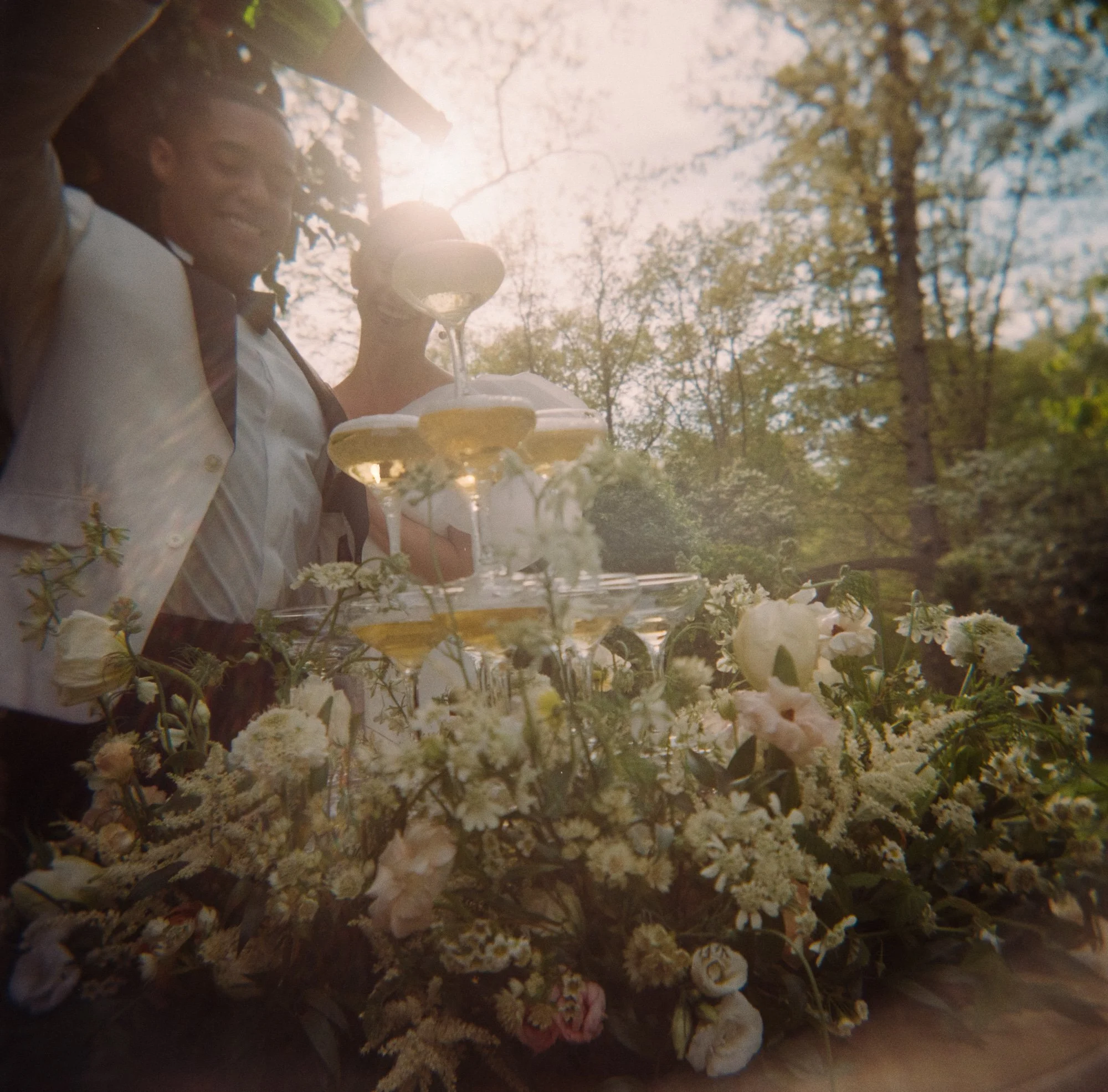 close up detail of a champagne tower with flowers