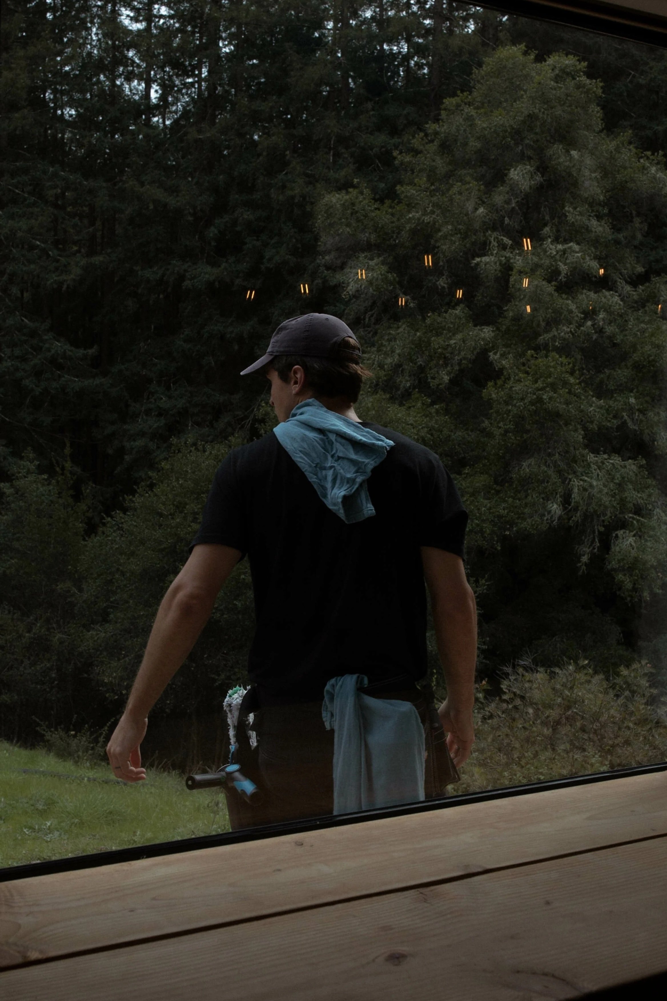 Professional exterior cleaning technician inspecting a residential property.