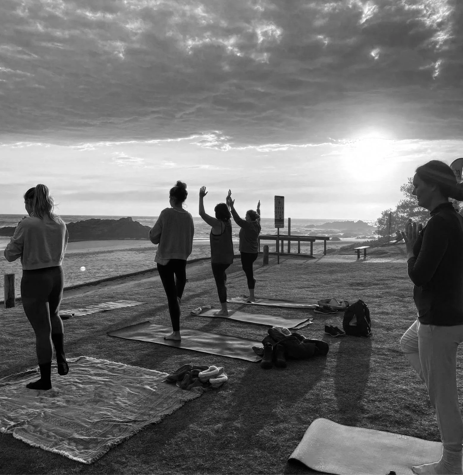 woman and man in childs pose on yoga mats