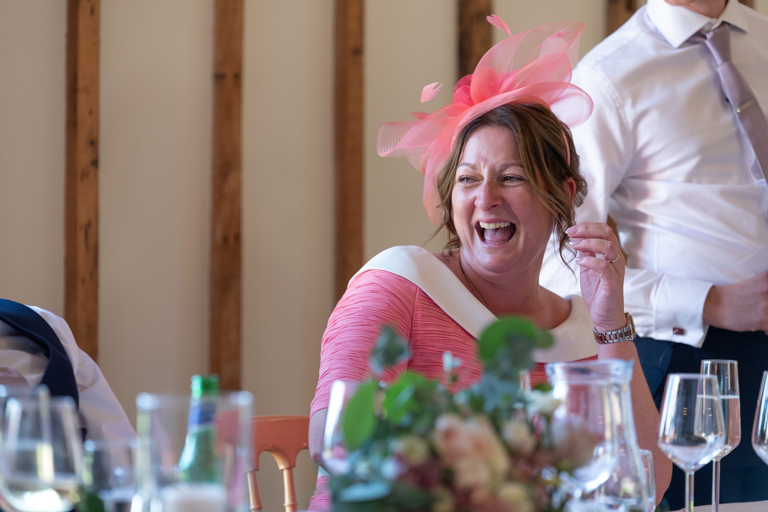  lady laughing at wedding speeches 
