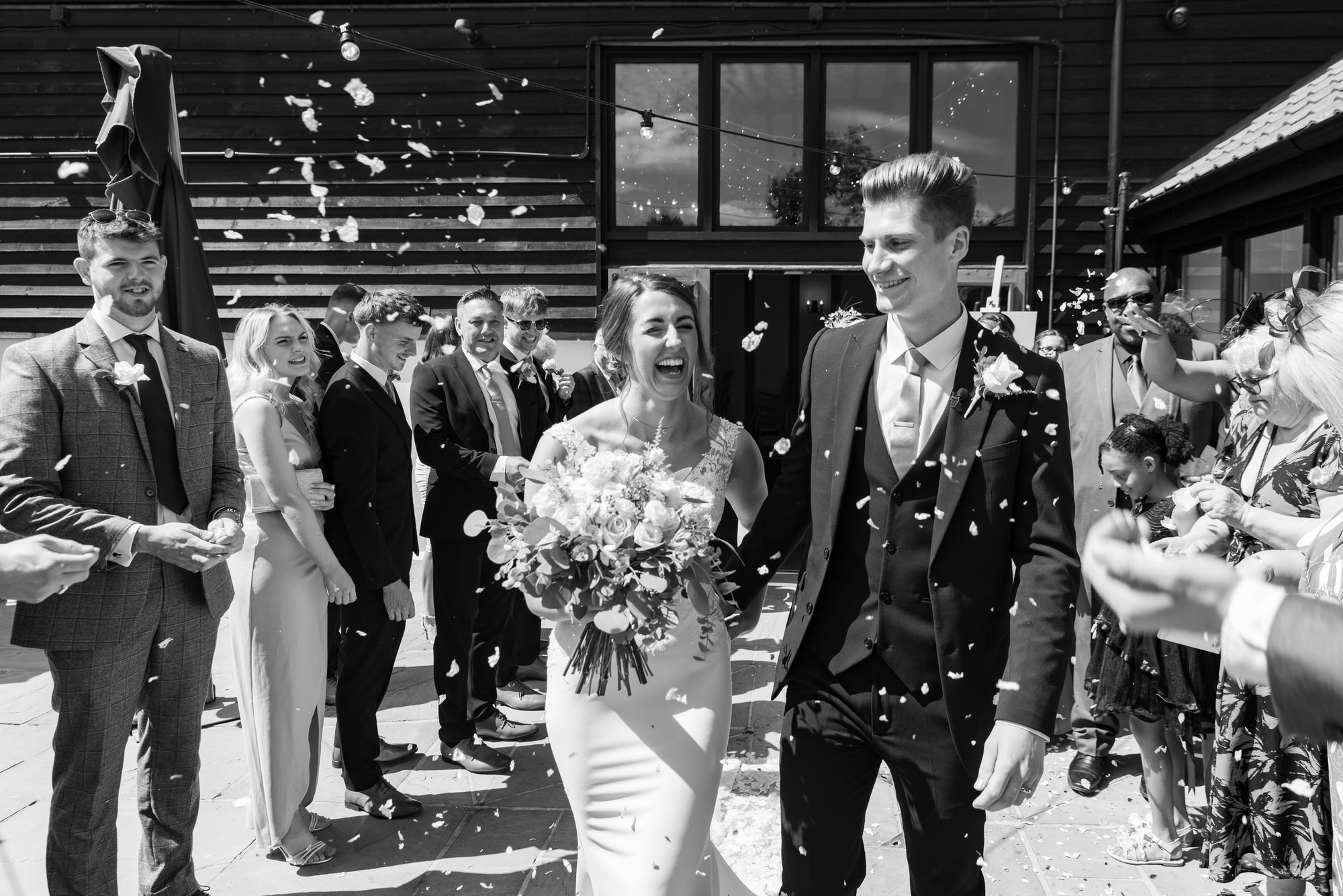  bride and groom walking through confetti throw 
