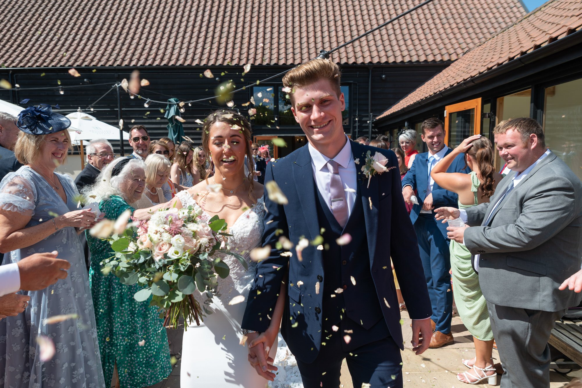  bride and groom walking through confetti throw 