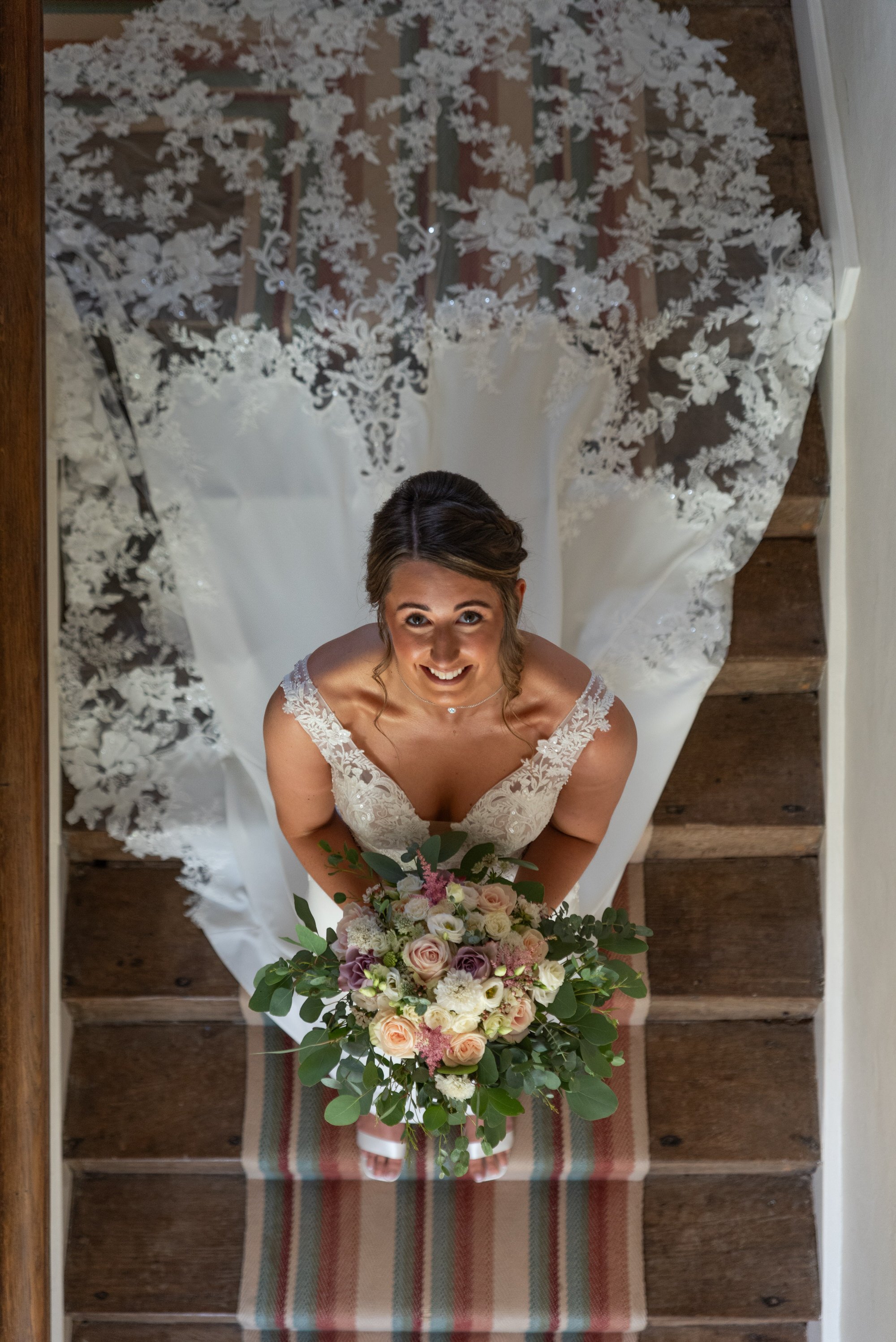  bride posing on stairs at Bruisyard Country Estate 