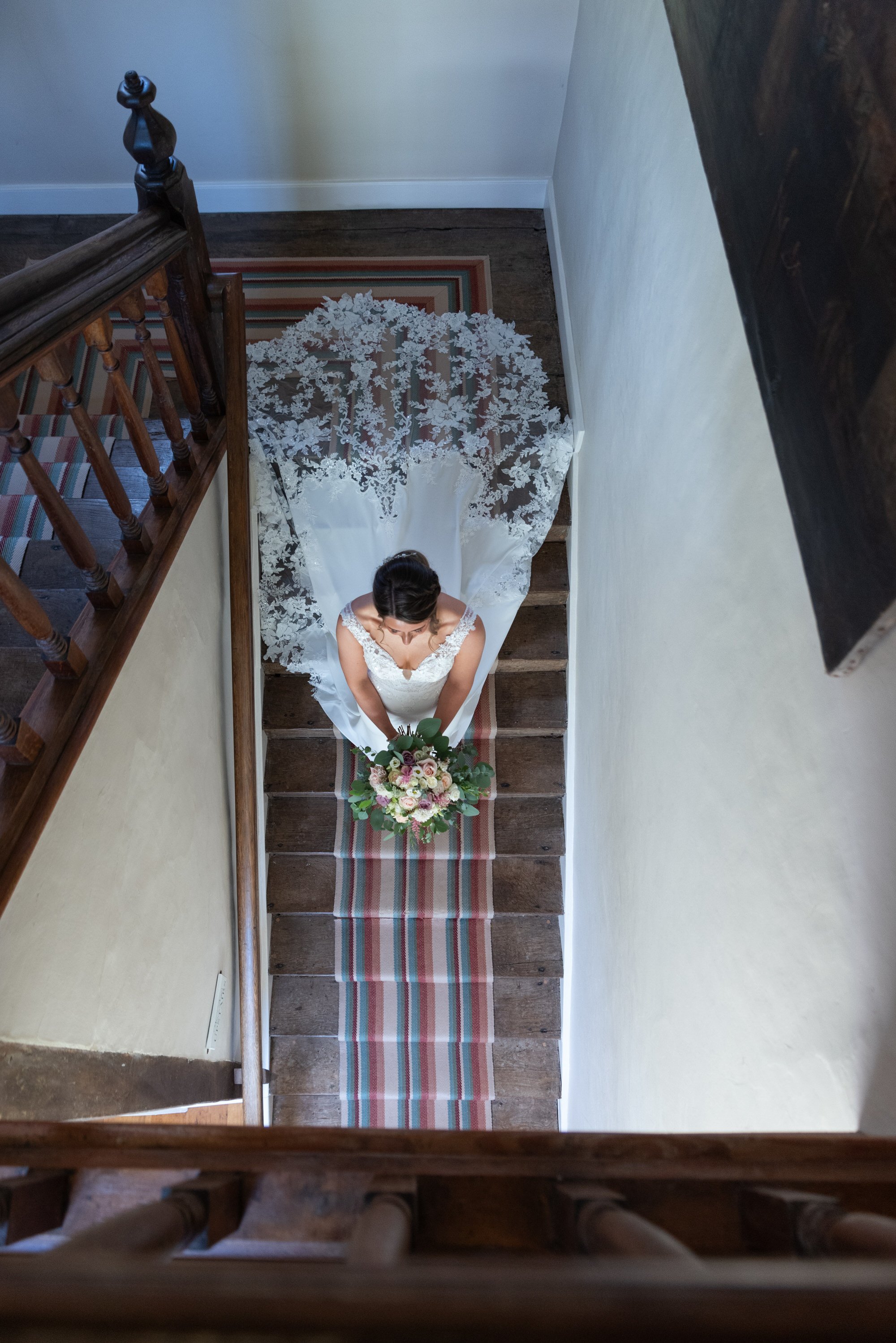  bride walking down stairs at suffolk wedding venue 