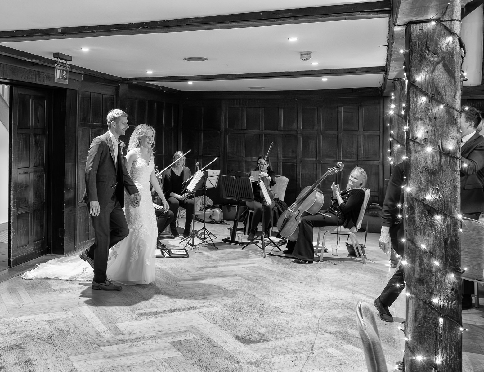 great-fosters-hotel-couple-wedding-breakfast-entry-orchestra-playing-music.jpg