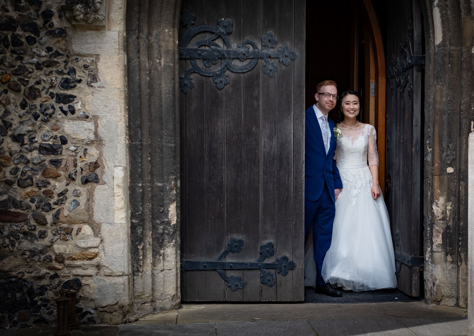 st-peter-st-mary-church-stowmarket-wedding-couple-emerge-doors.jpg