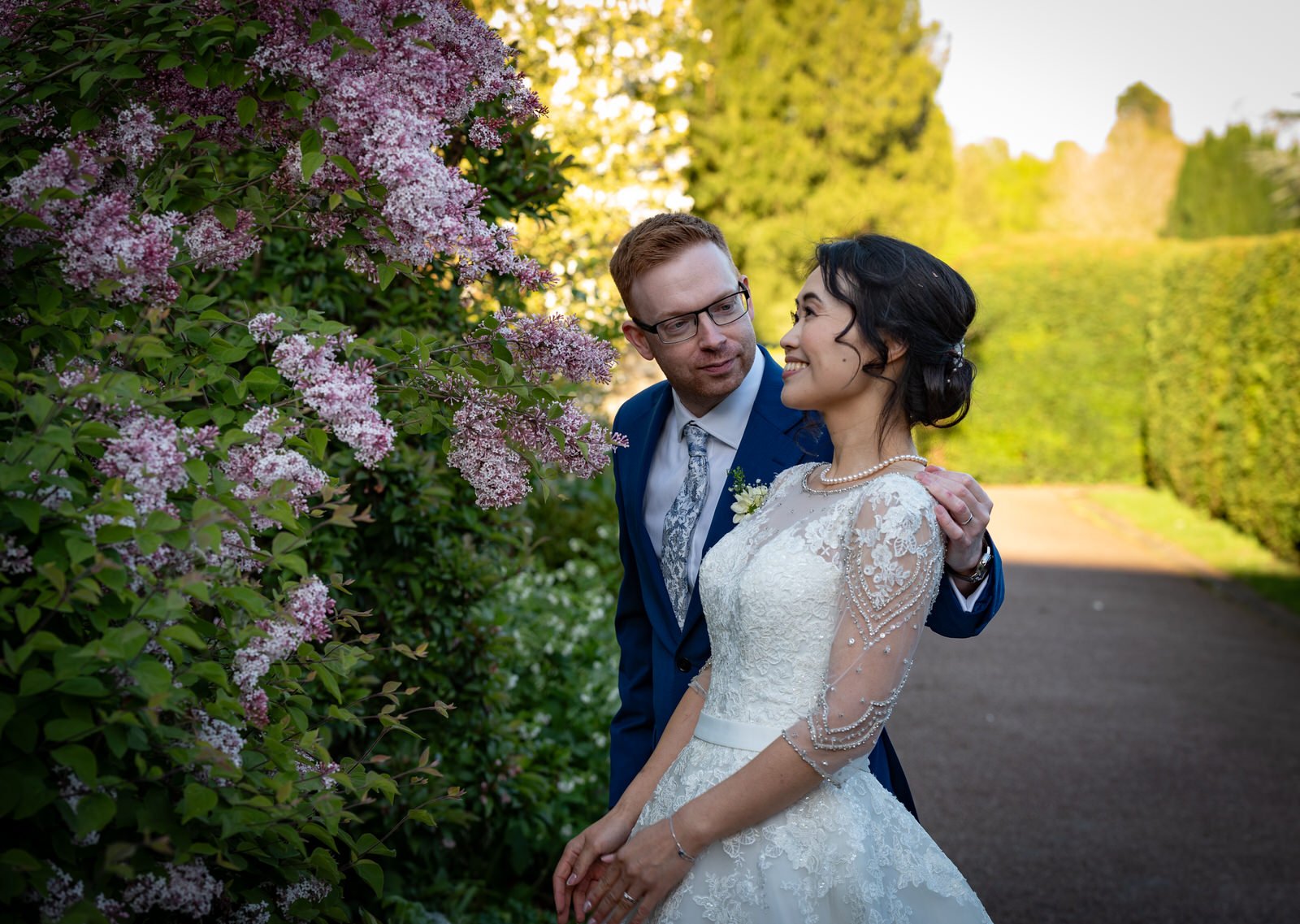 abbey-gardens-wedding-couple-admire-blossom.jpg