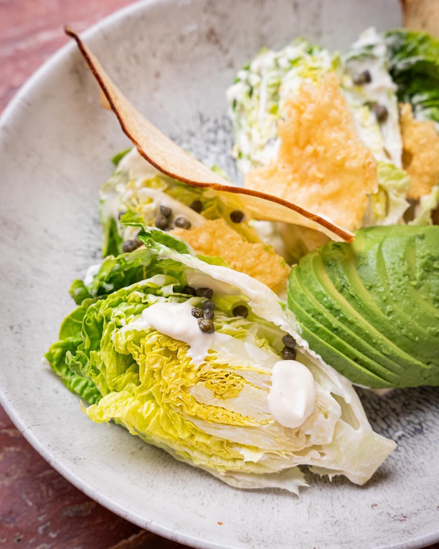 Crisp baby gem lettuce with crunchy homemade croutons, our creamy parmesan dressing, capers, avocado and a soft-boiled egg. This classic Caesar Salad can be enjoyed with or without grilled chicken and we recommend adding a side of truffled triple coo