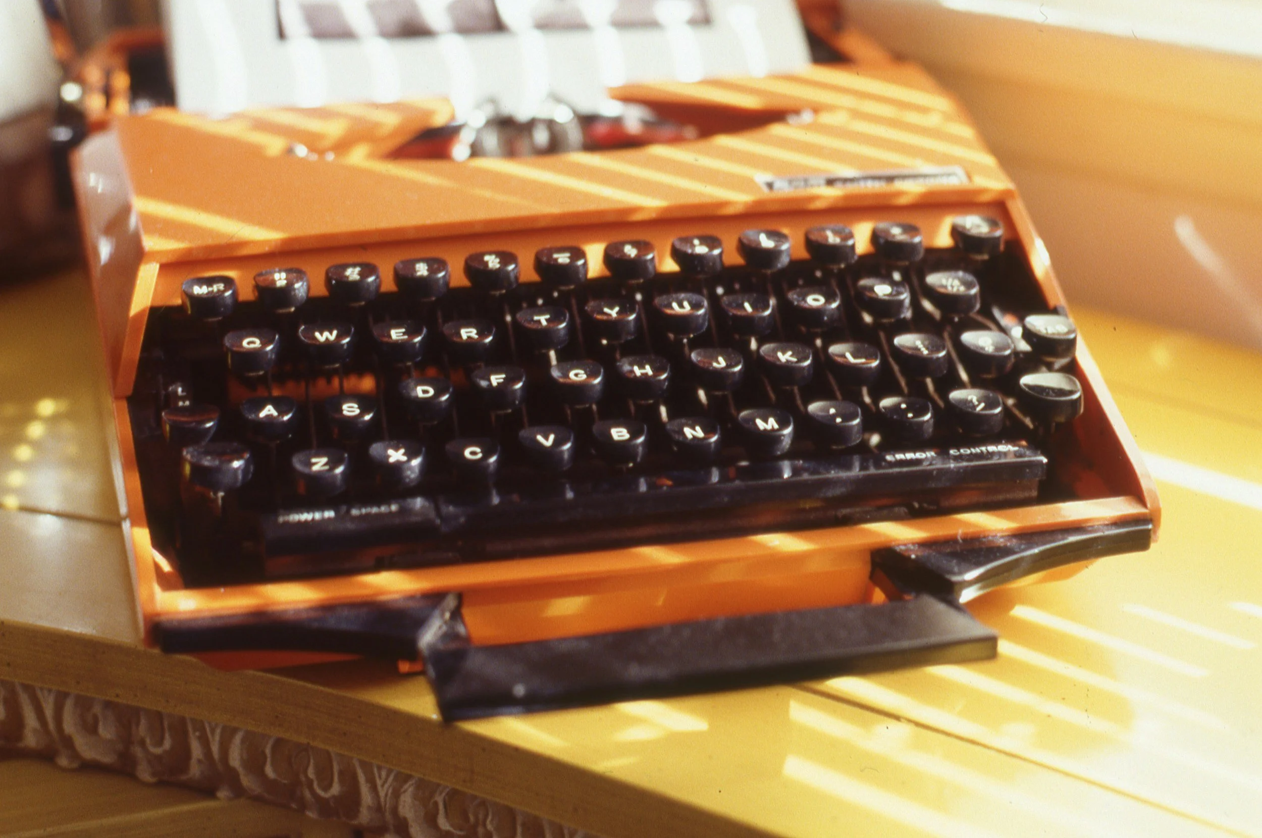 orange typewriter in the sunlight