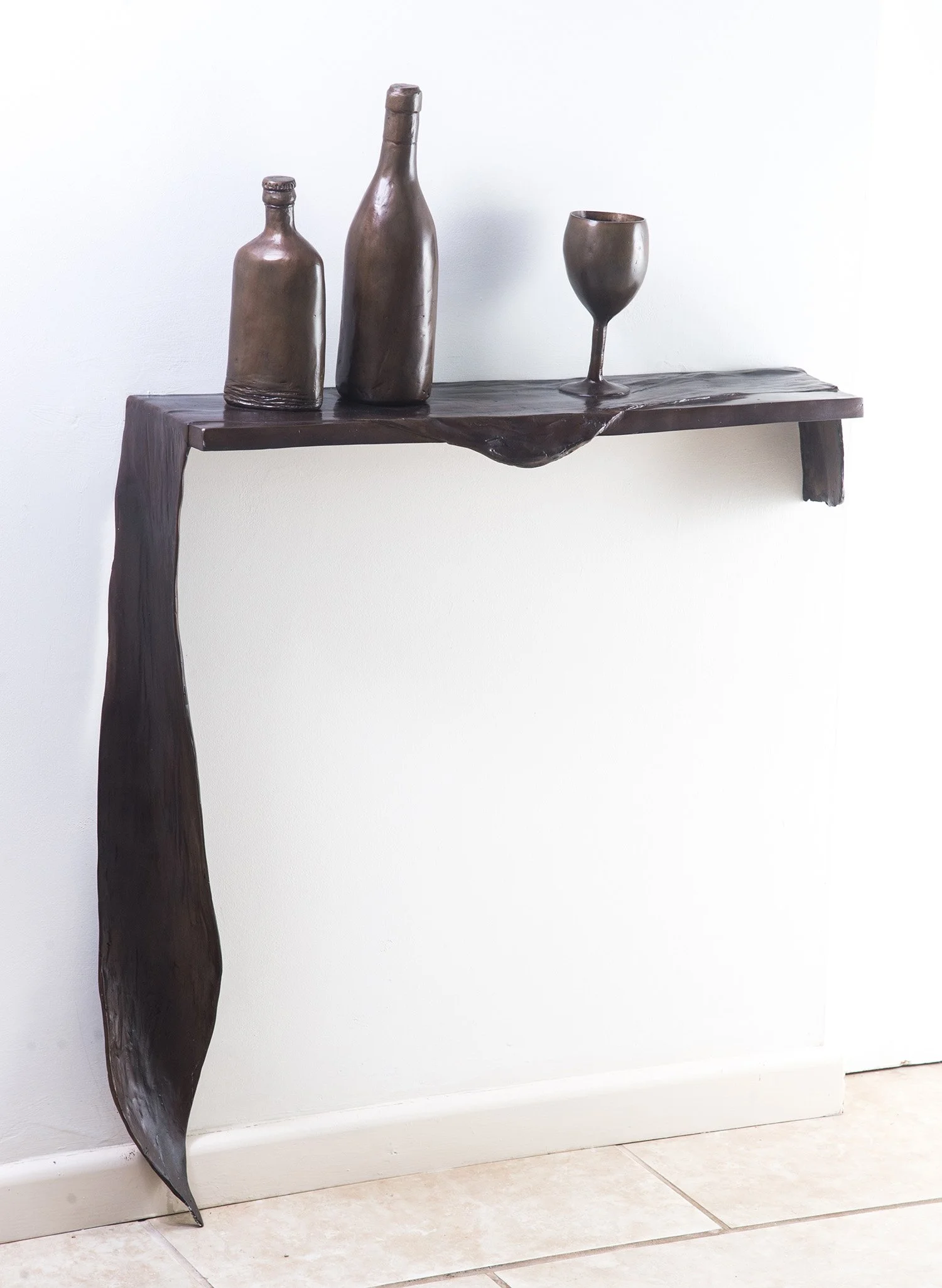 Still Life X life size bronze sculpture draped cloth bottles and wine glass on shelf