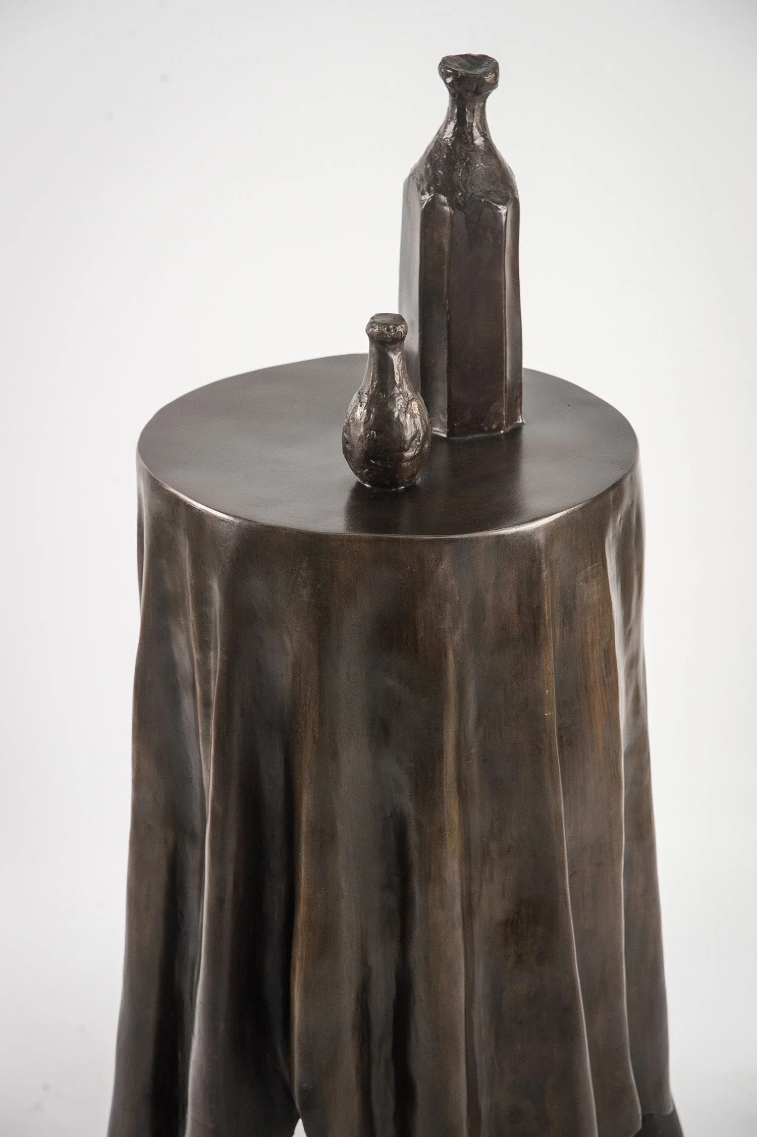 Still Life VI life size bronze sculpture of  circular table tablecloth and bottles