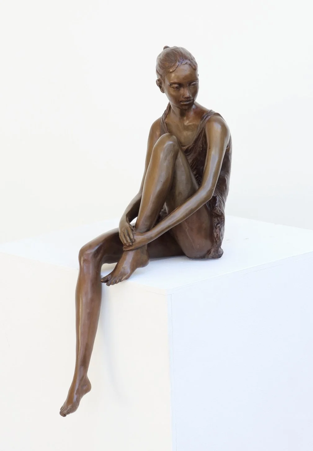 Dreaming Dancer Study small bronze sculpture female figure a dancer sitting hugging one leg depicted in a moment of dreaming side view