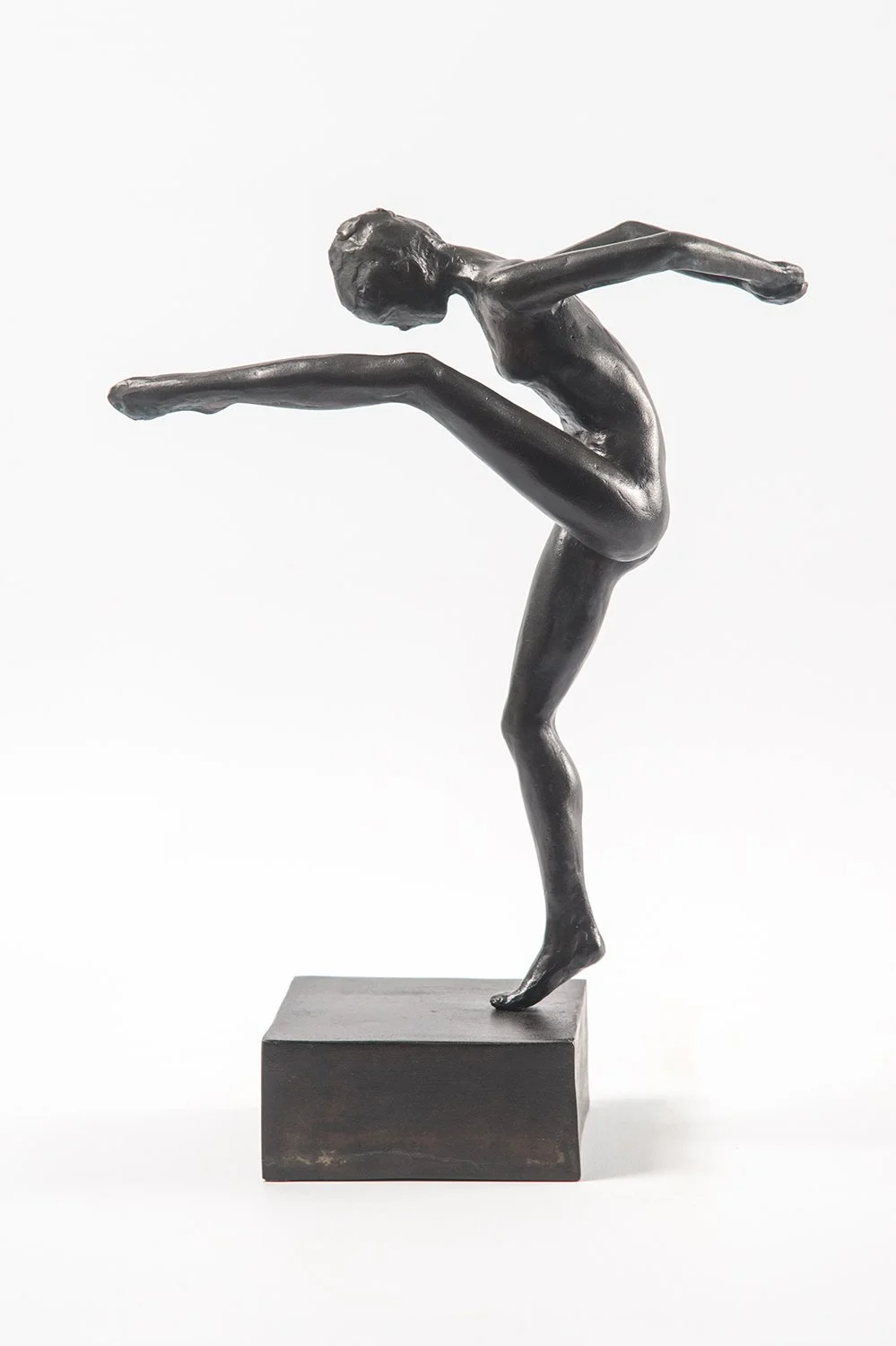 Study in Movement Female I small bronze sculpture study female figure in movement one leg raised high toes pointed hands clasped behind back head bent over nose to knee