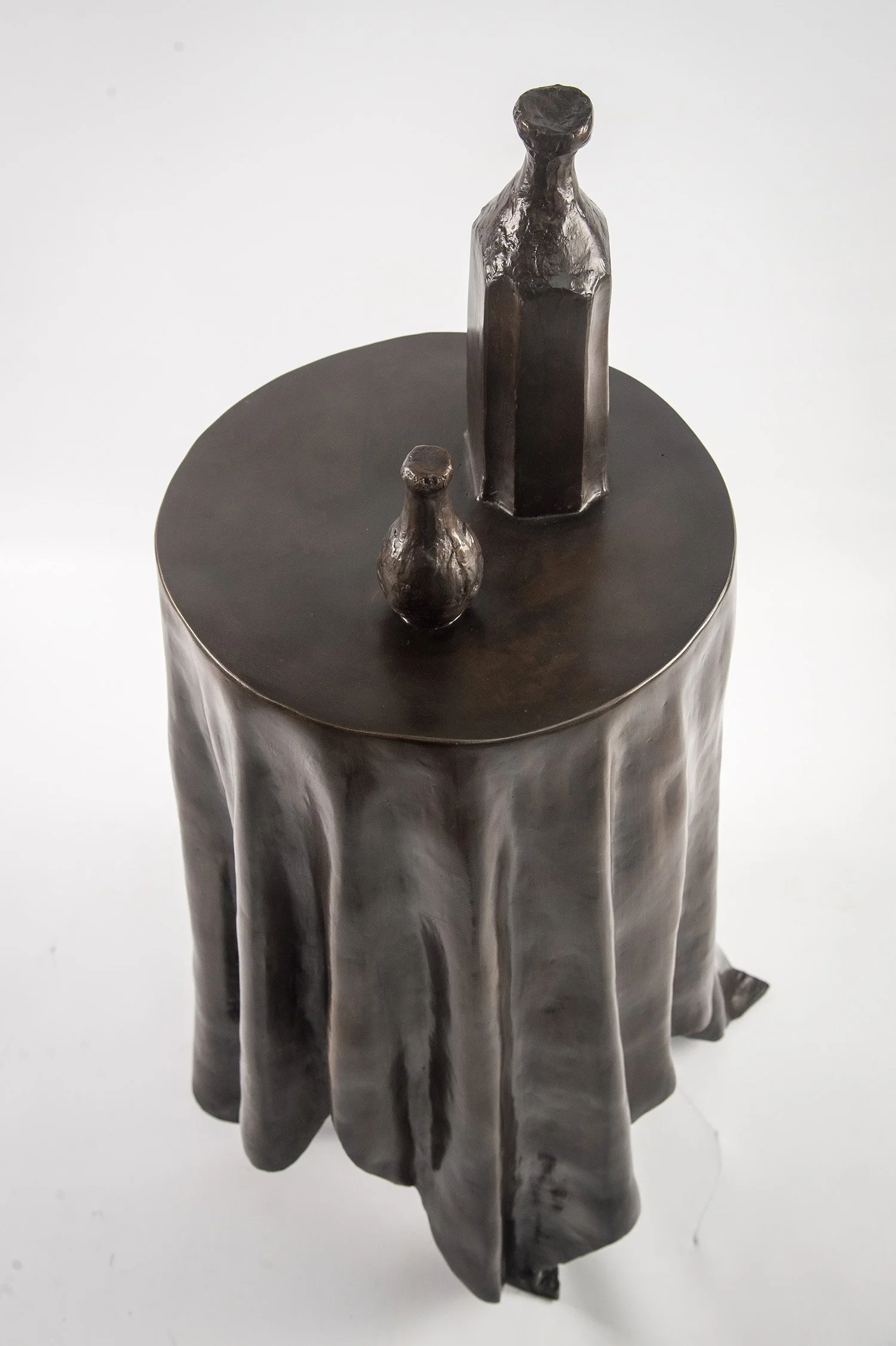 Still Life VI life size bronze sculpture of  circular table tablecloth and bottles