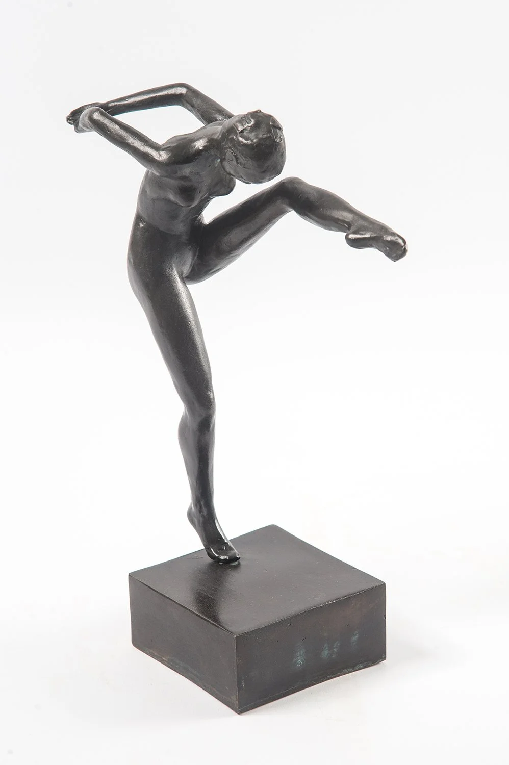 Study in Movement Female I small bronze sculpture study female figure in movement one leg raised high toes pointed hands clasped behind back head bent over nose to knee
