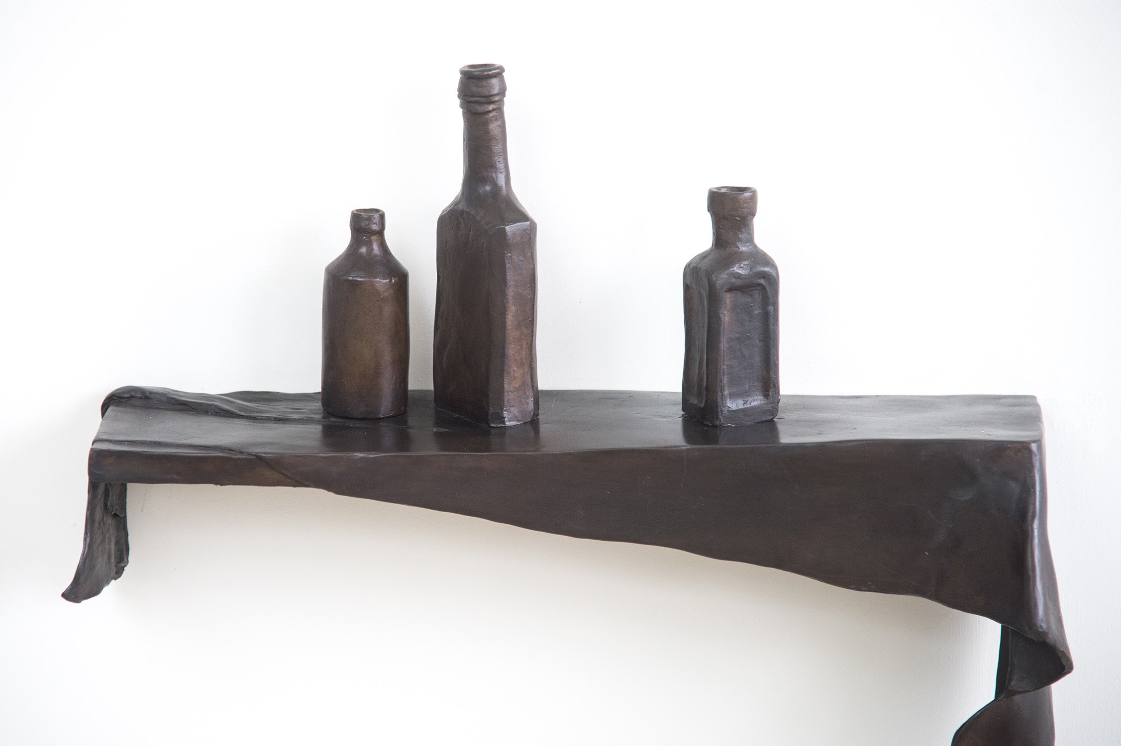Still Life VIII life size bronze sculpture draped cloth and bottles on shelf