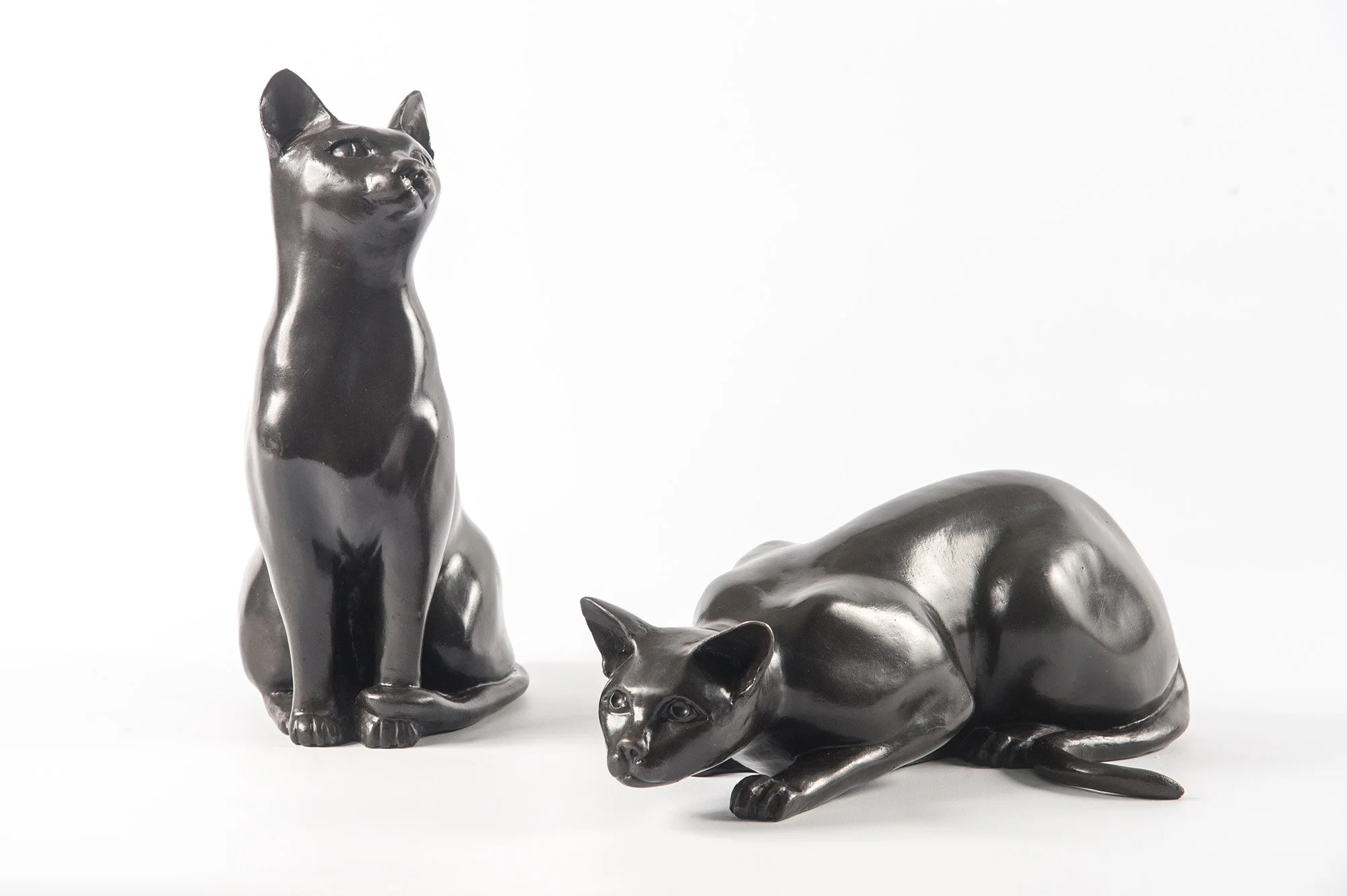 Cats – Crouching and Watching life size bronze sculptures of cats one crouching one sitting watching