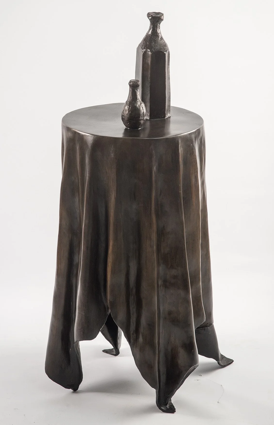 Still Life VI life size bronze sculpture of  circular table tablecloth and bottles