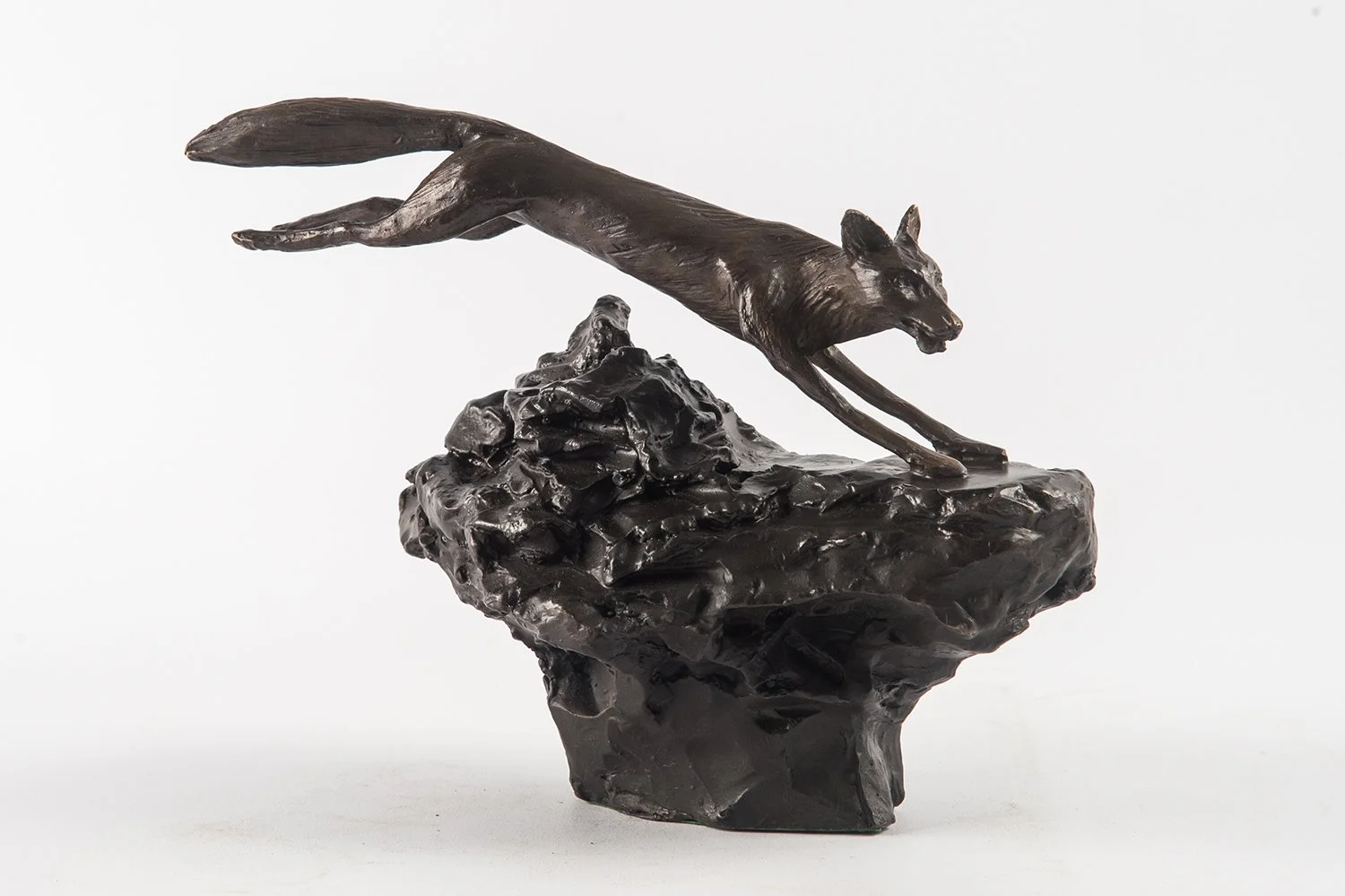 Fox study small bronze sculpture of fox leaping over rough ground