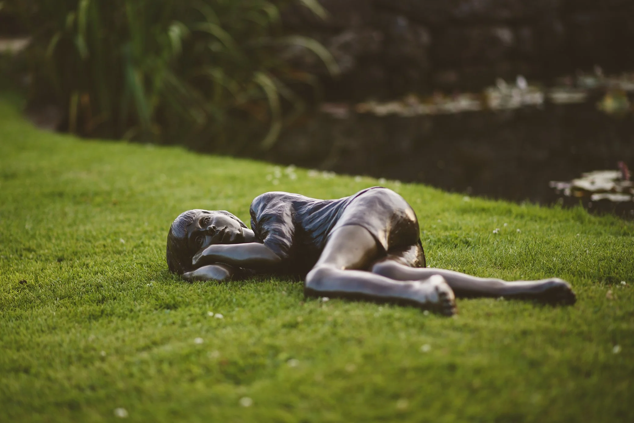 Resting Child Life-Size Sculpture by Judith Holmes Drewry.jpg