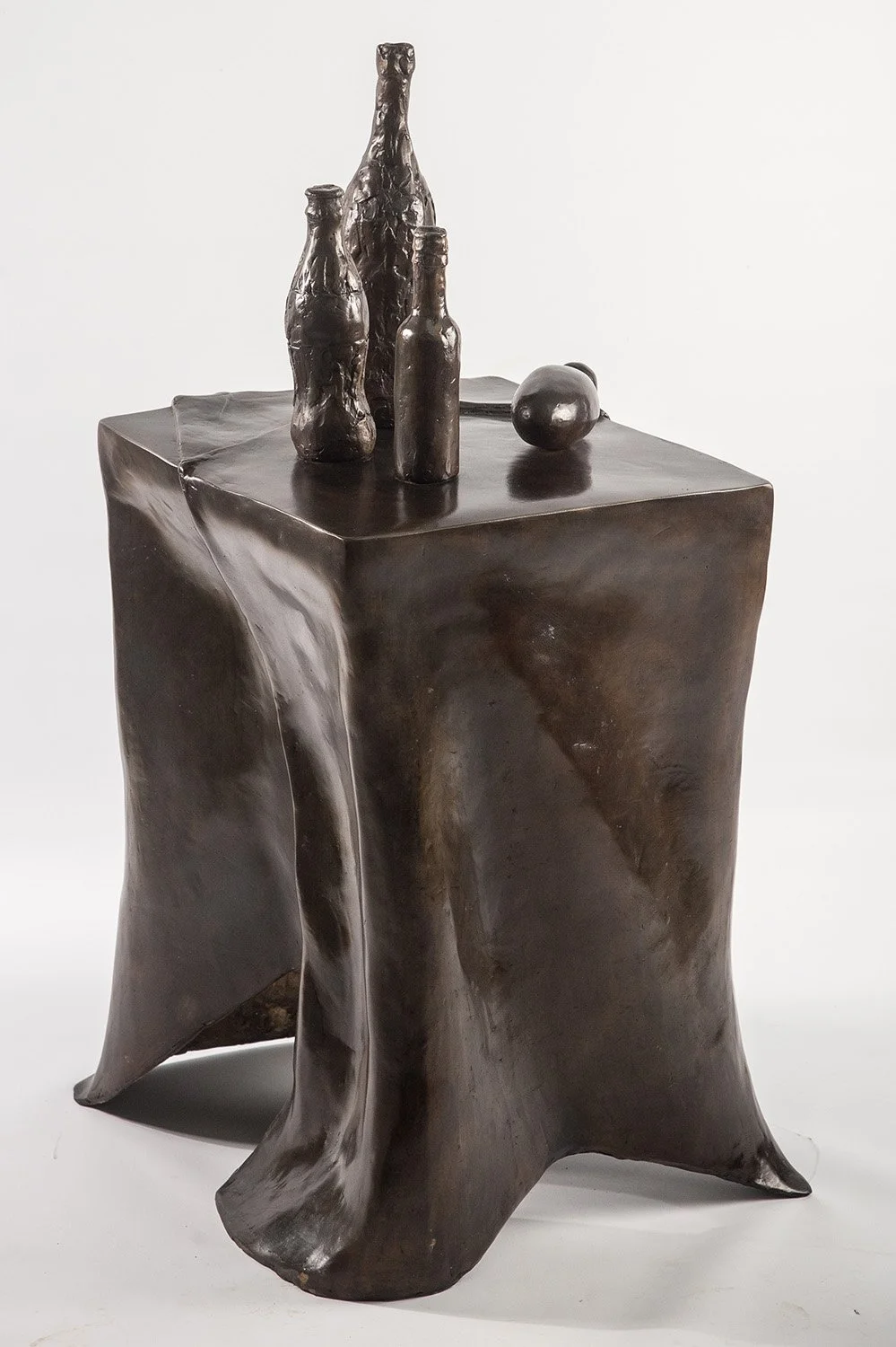 Still Life VII life size bronze sculpture of table draped tablecloth and bottles