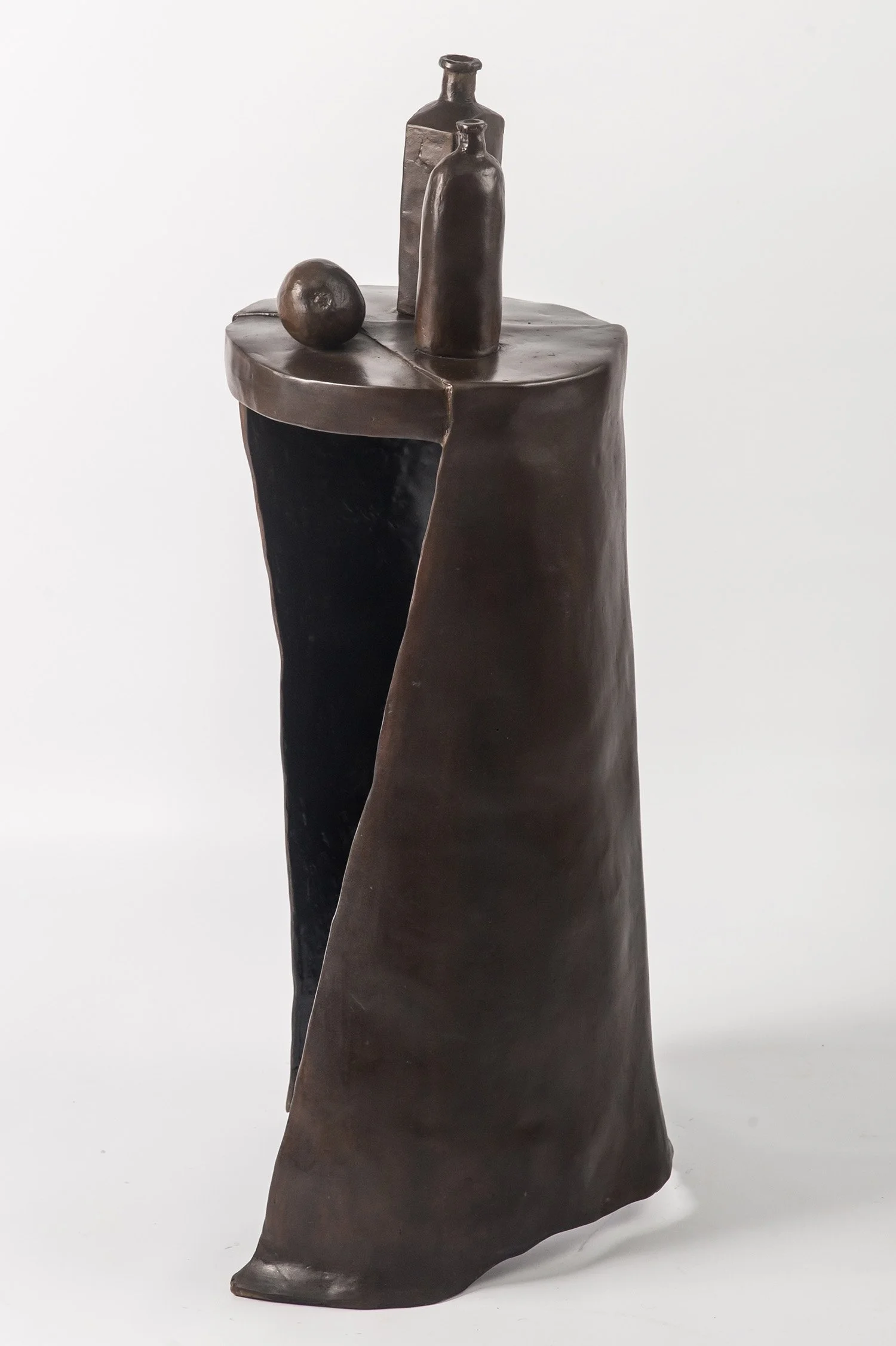 Still Life XIV life size bronze sculpture a pear and bottles placed on circular surface draped with a cloth