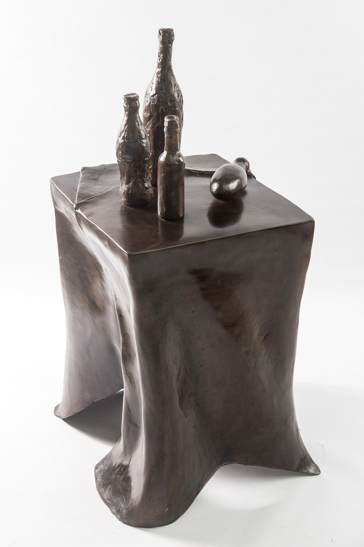 Still Life VII life size bronze sculpture of table draped tablecloth and bottles