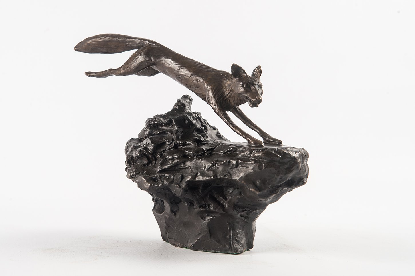Fox study small bronze sculpture of fox leaping over rough ground
