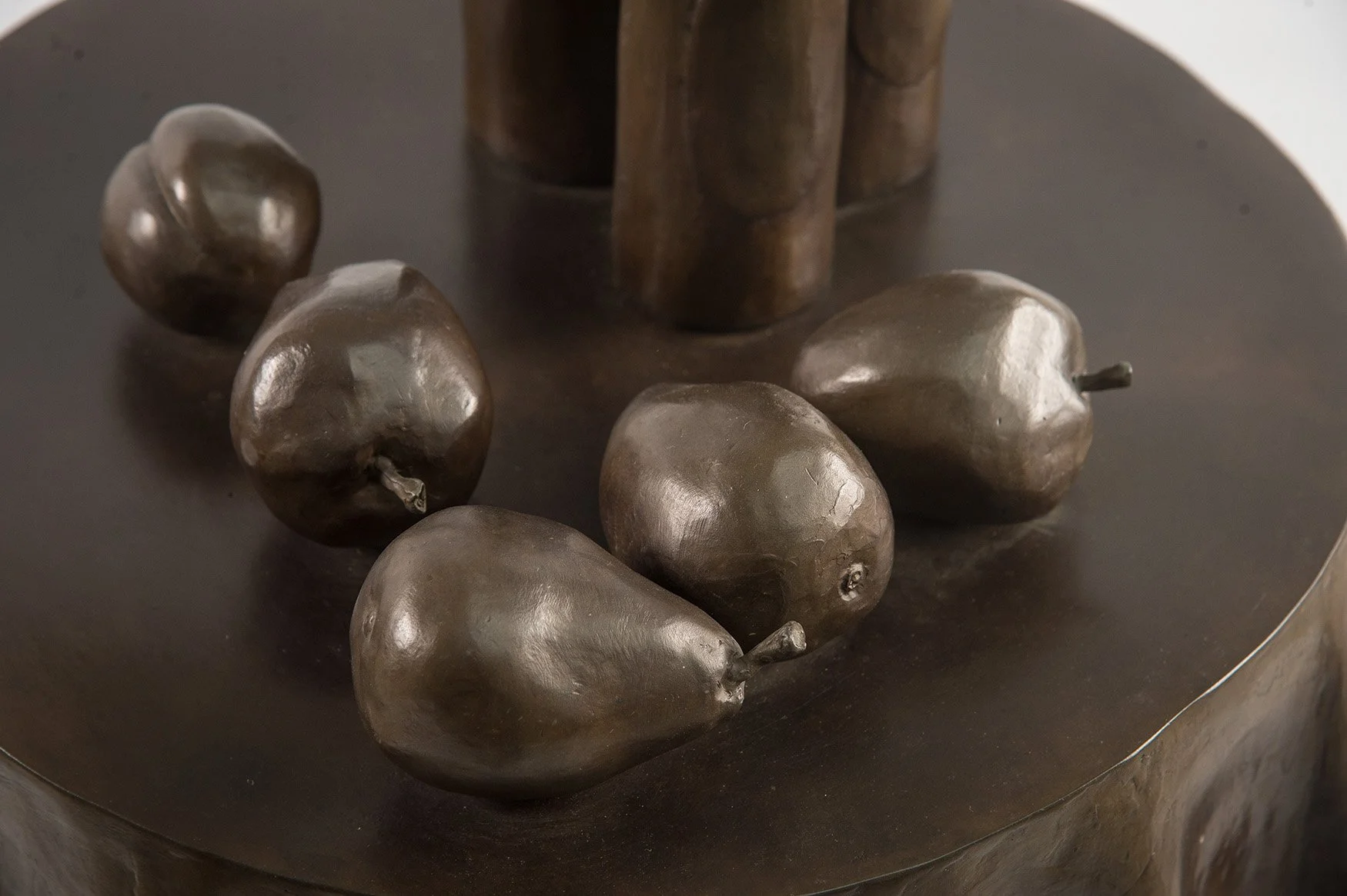 Still Life IX life size bronze sculpture table with cloth bottles and fruit close up view