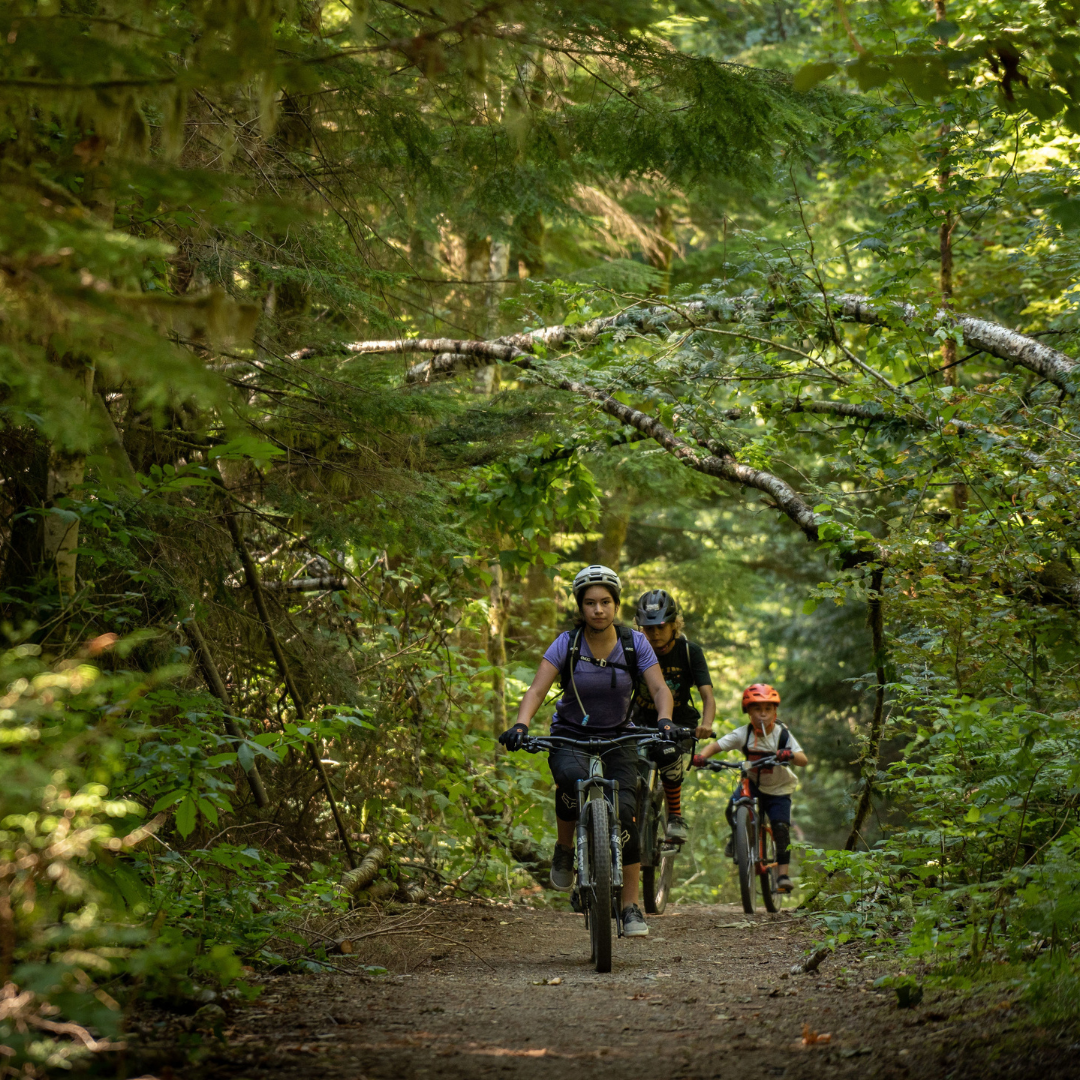 Squamish Nation Youth riding mountain bikes.png
