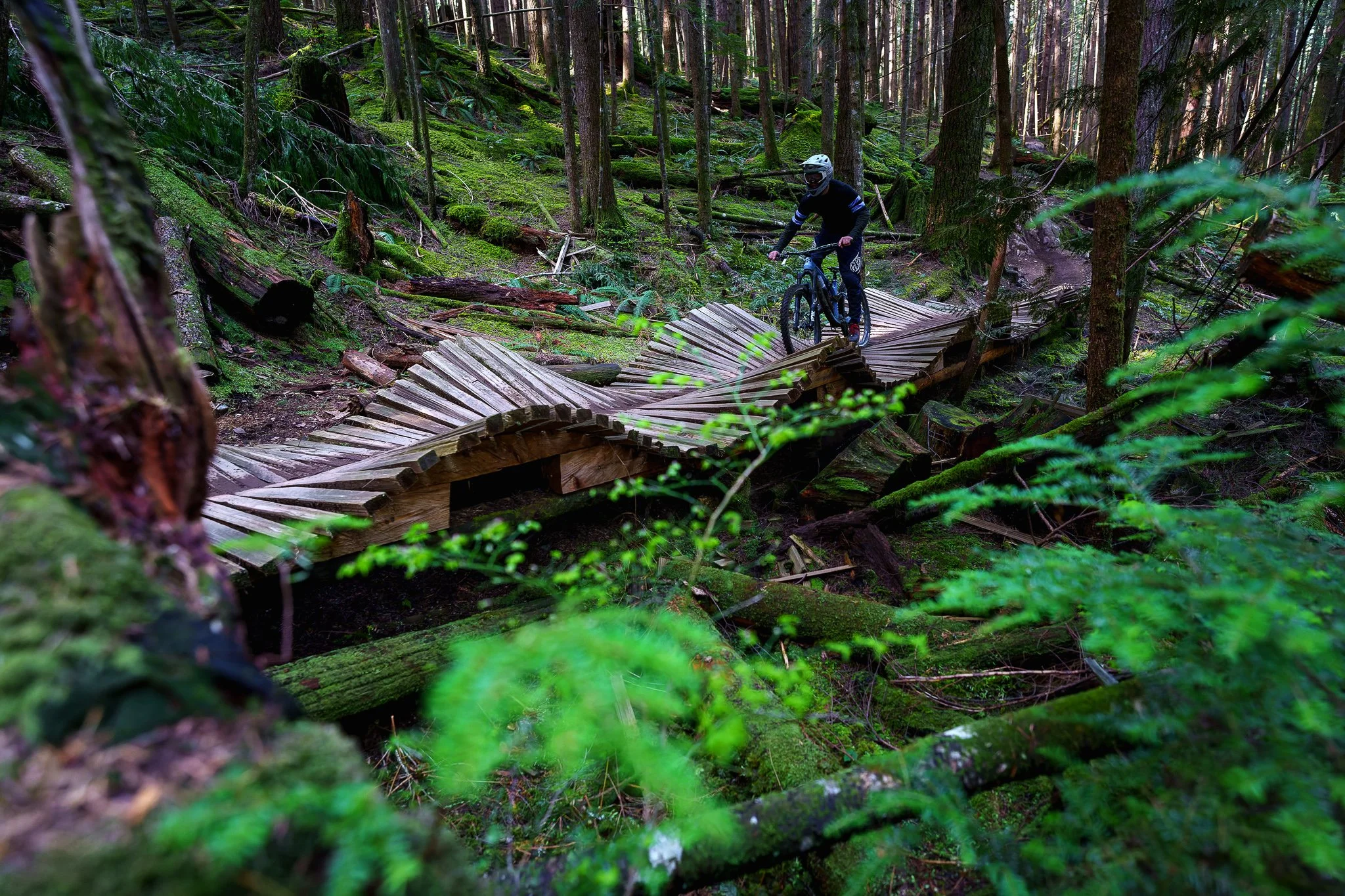A mountain biker riding over a bridge in Squamish, BC