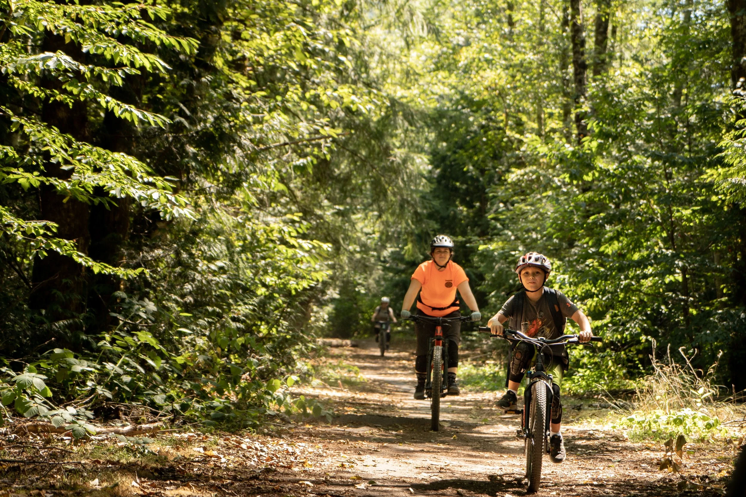 Mountain bikers riding a flat trail in the forest